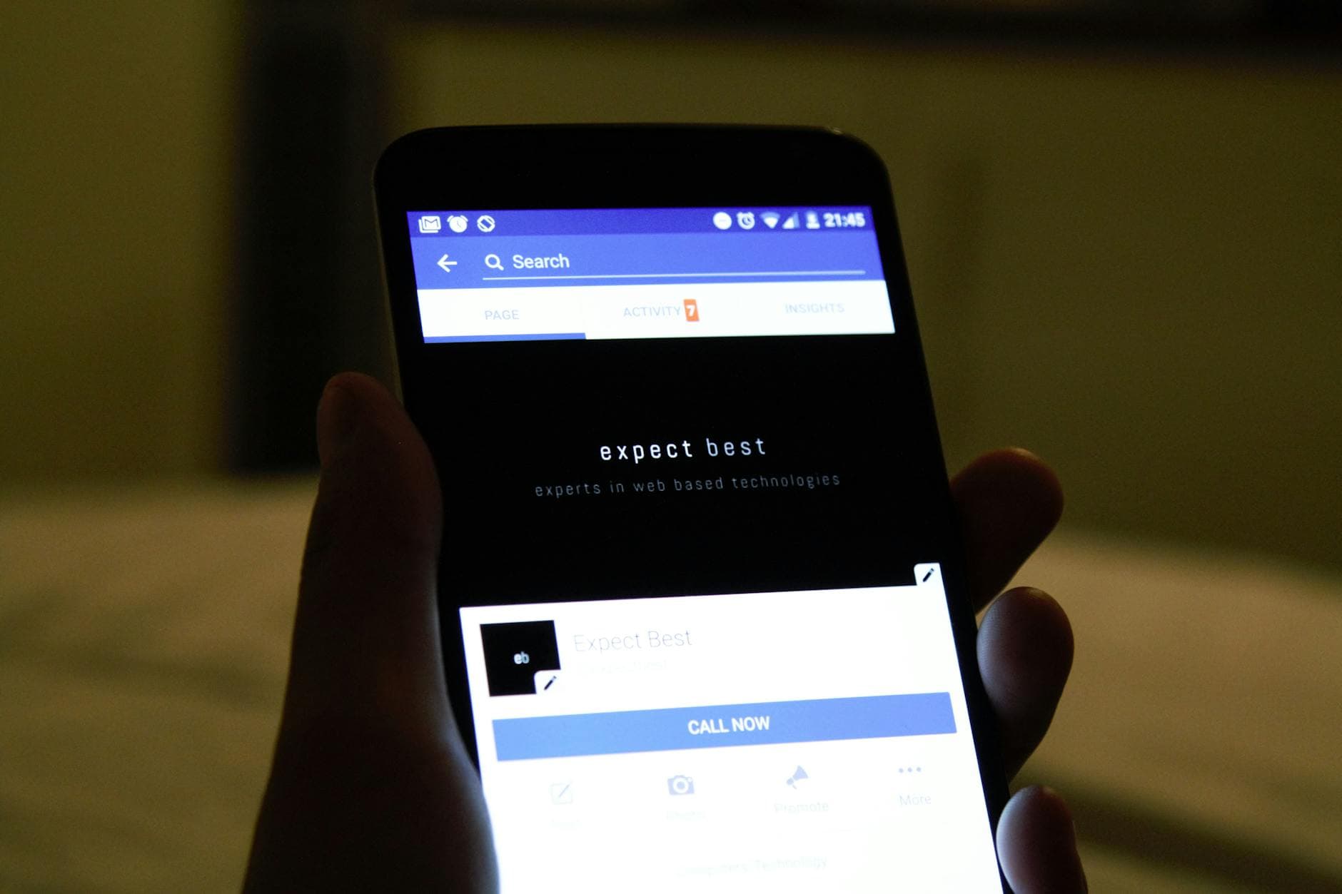 Close-up of a hand holding a smartphone showing a social media application screen. - best walking app