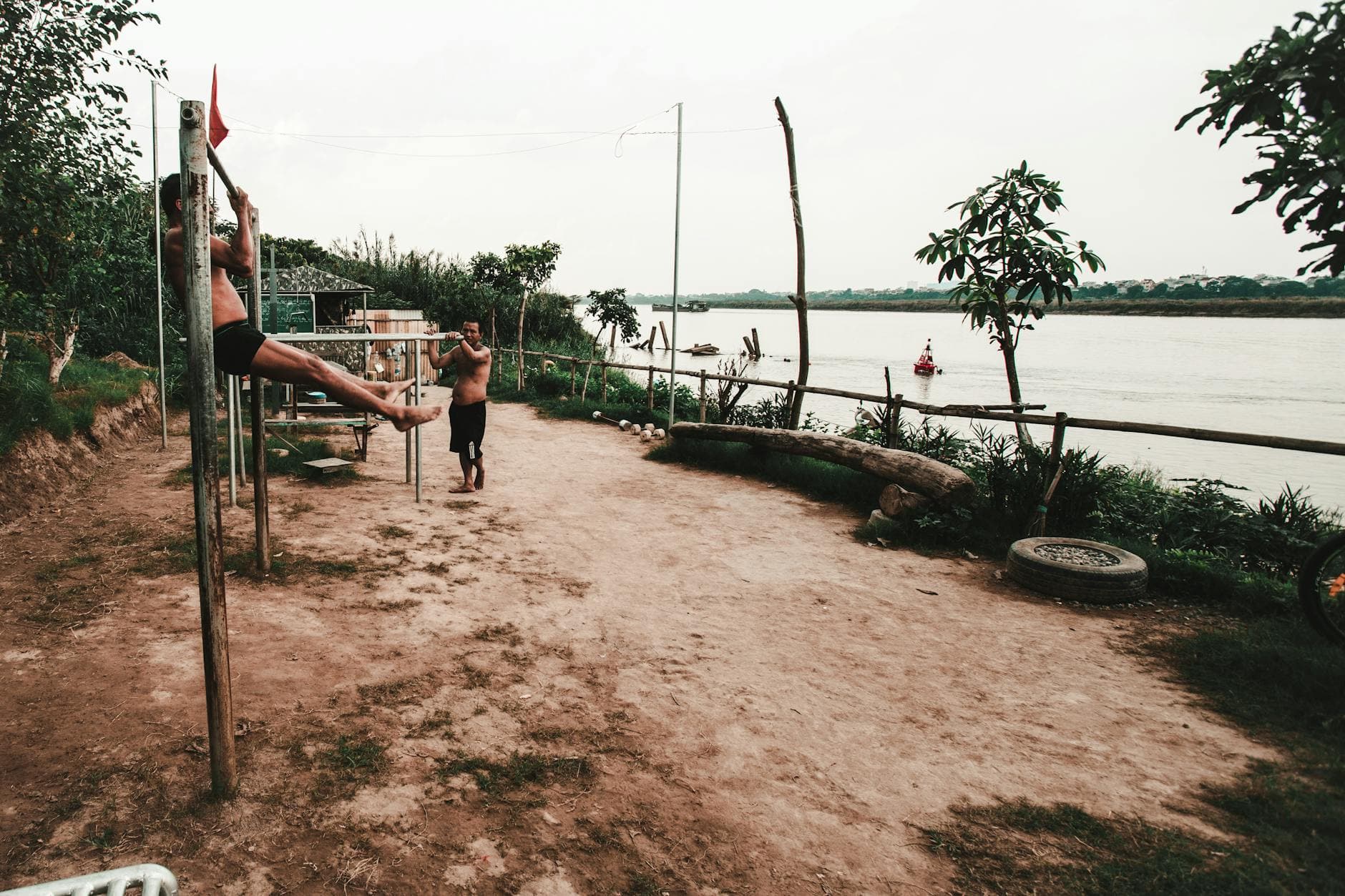 Men working out by the river in Hanoi, Vietnam, showcasing fitness and outdoor exercise. - cardio workouts for men