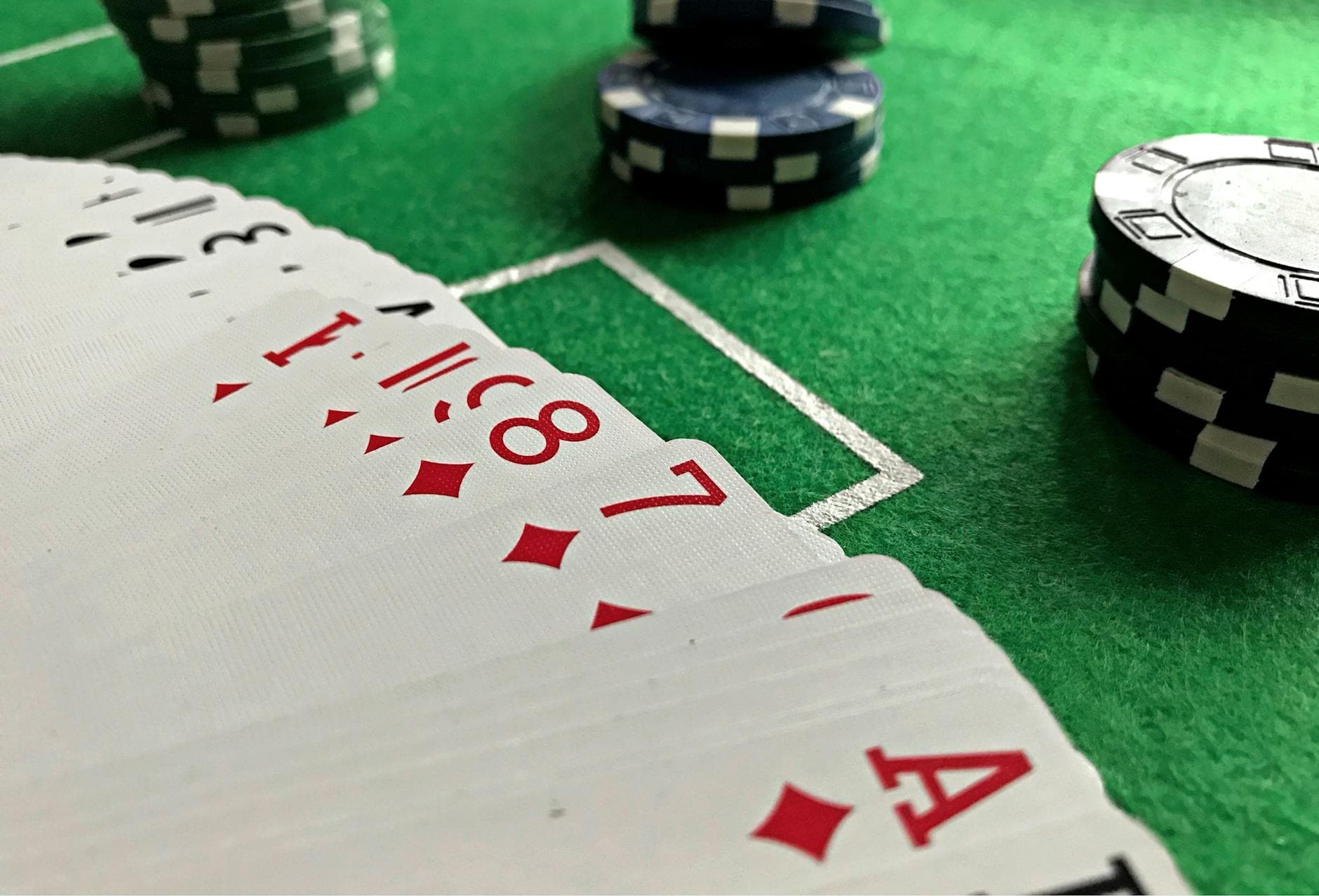 Close-up view of poker cards and chips on a green felt table, perfect for casino-themed content. - healthy chips