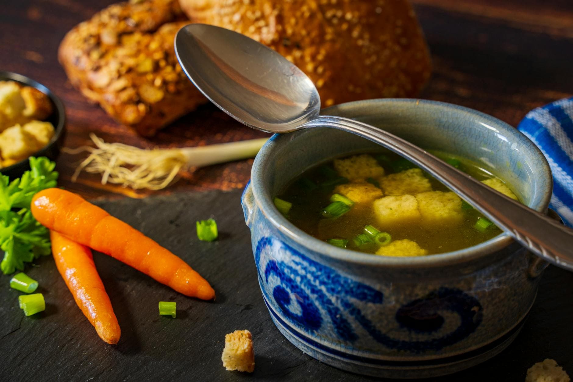 Delicious vegetable broth with croutons served in a blue bowl, perfect for a comforting winter meal. - iron rich foods