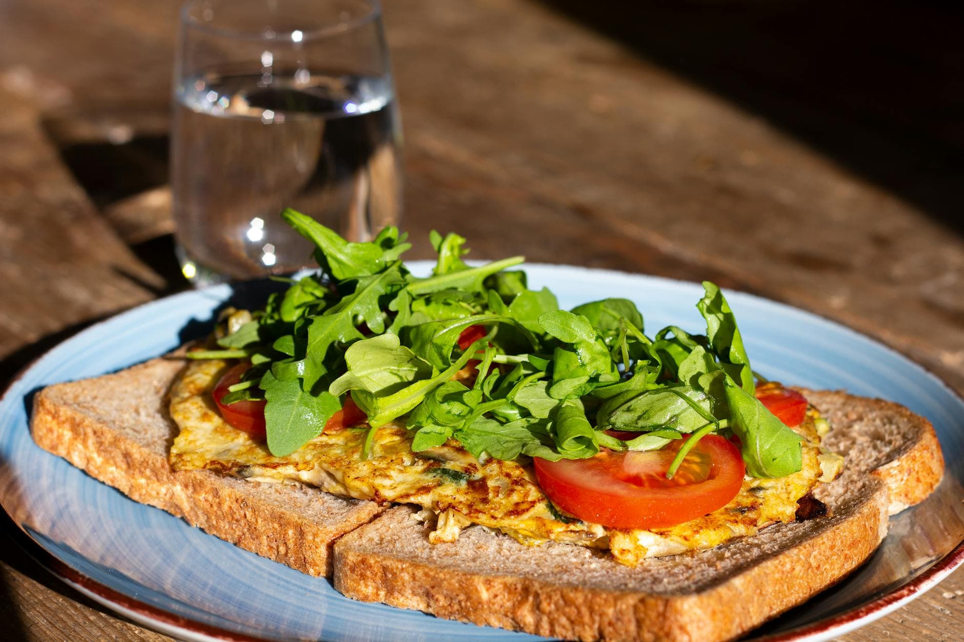 Delicious open-faced omelette sandwich with fresh greens on rustic bread, perfect for breakfast or brunch. - quick healthy breakfast
