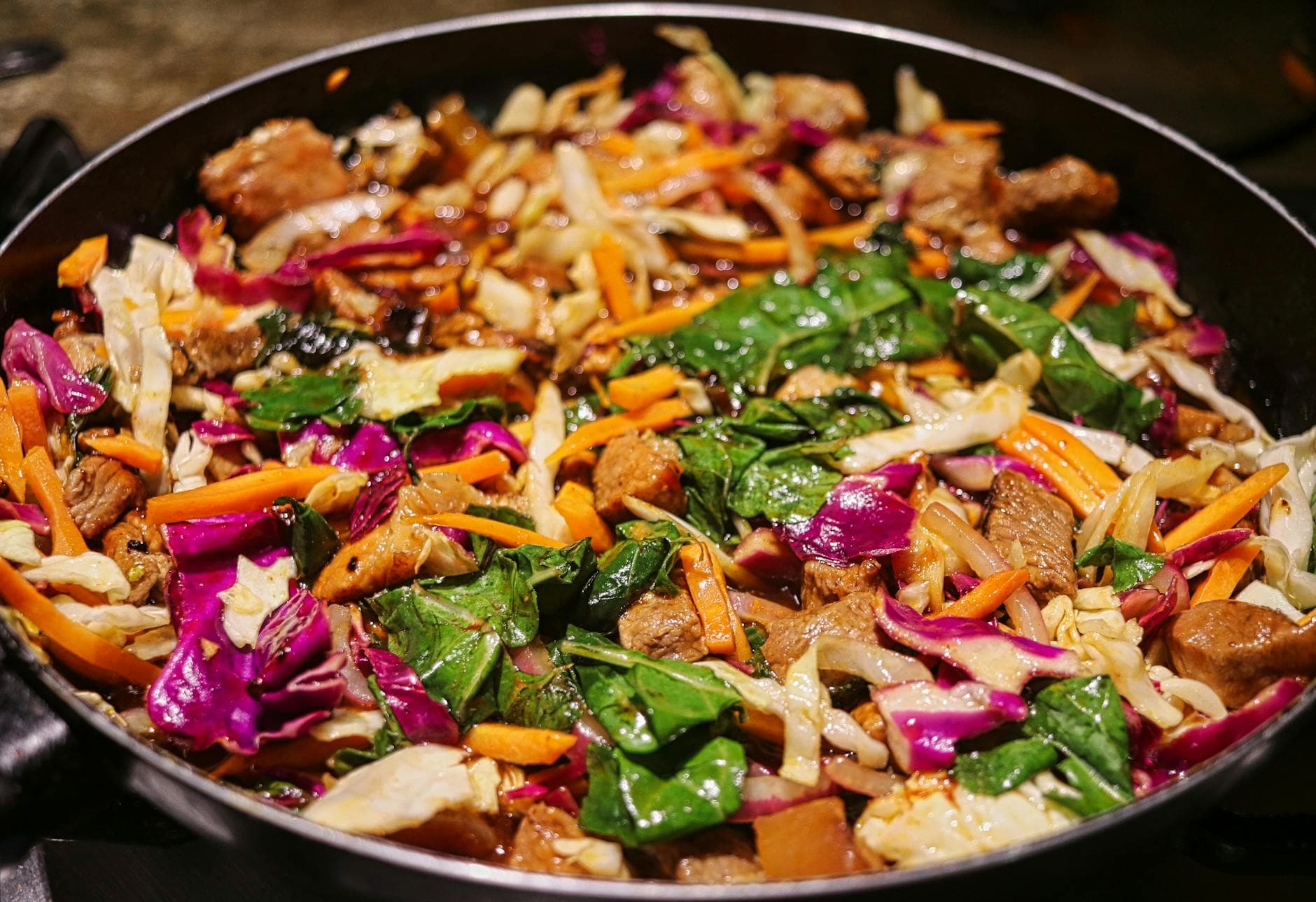 Colorful stir-fry of beef and mixed vegetables in a pan, showcasing fresh ingredients. - quick healthy dinners