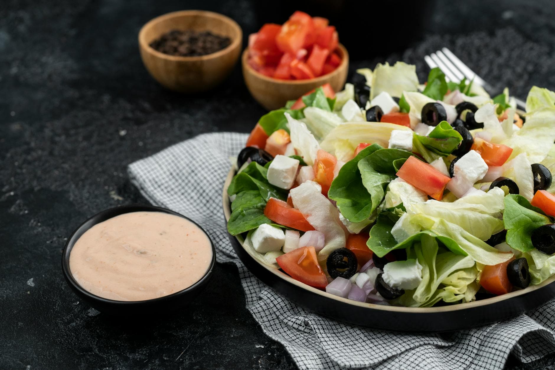 Delicious Greek salad with fresh vegetables, feta cheese, and black olives. - spring plant based salads