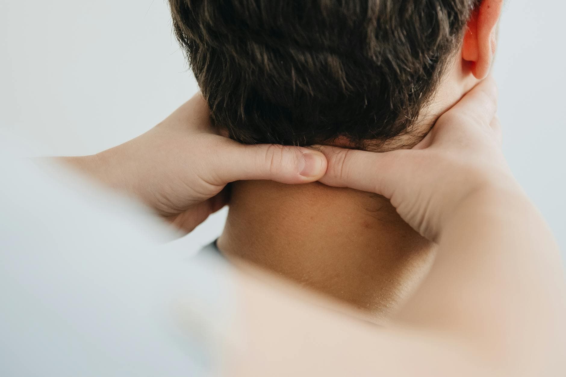 Close-up of a therapist massaging a patient's neck for pain relief and relaxation. - stress relief techniques