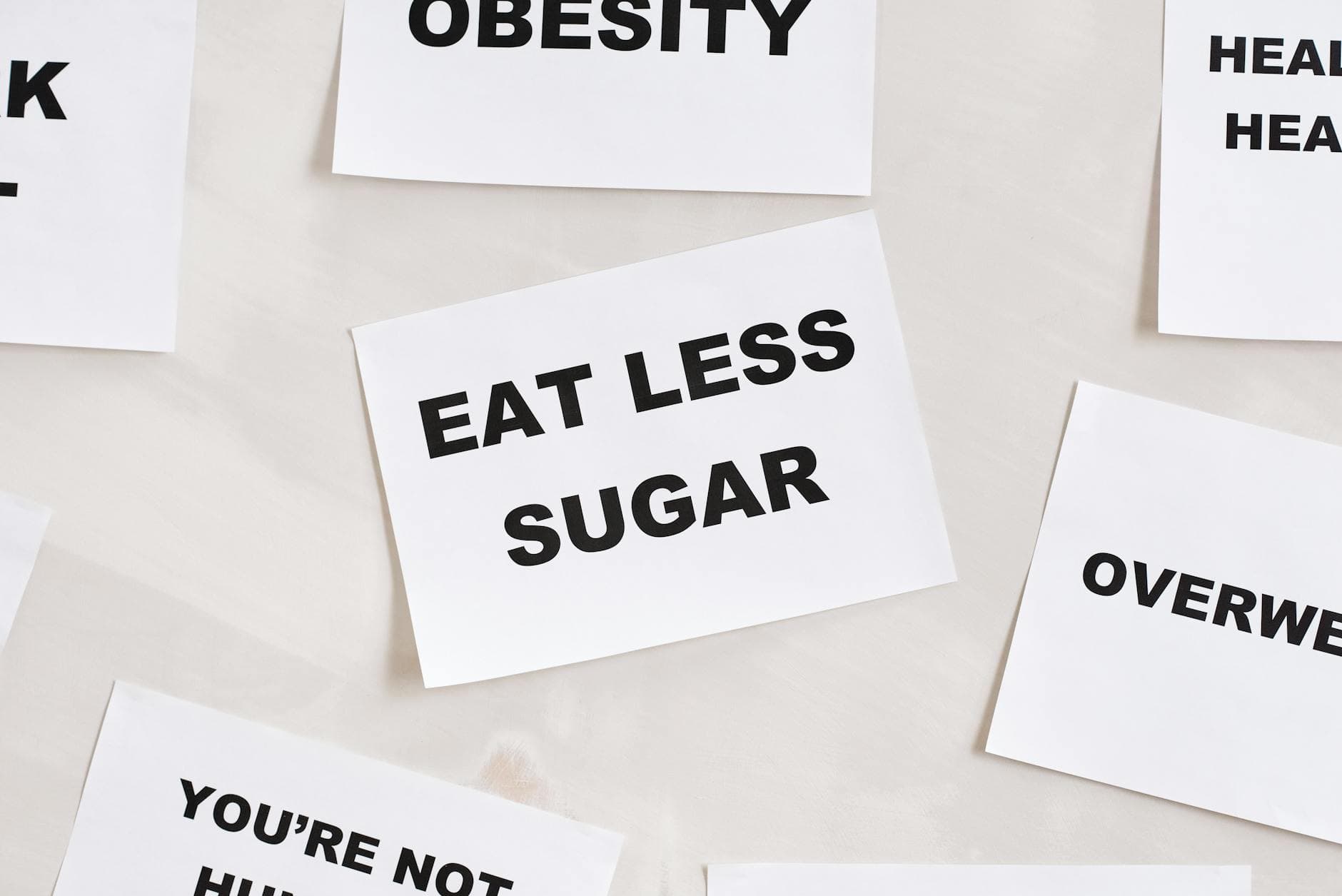 Minimalist photograph of motivational cards with healthy lifestyle messages on a white background. - walk for weight loss