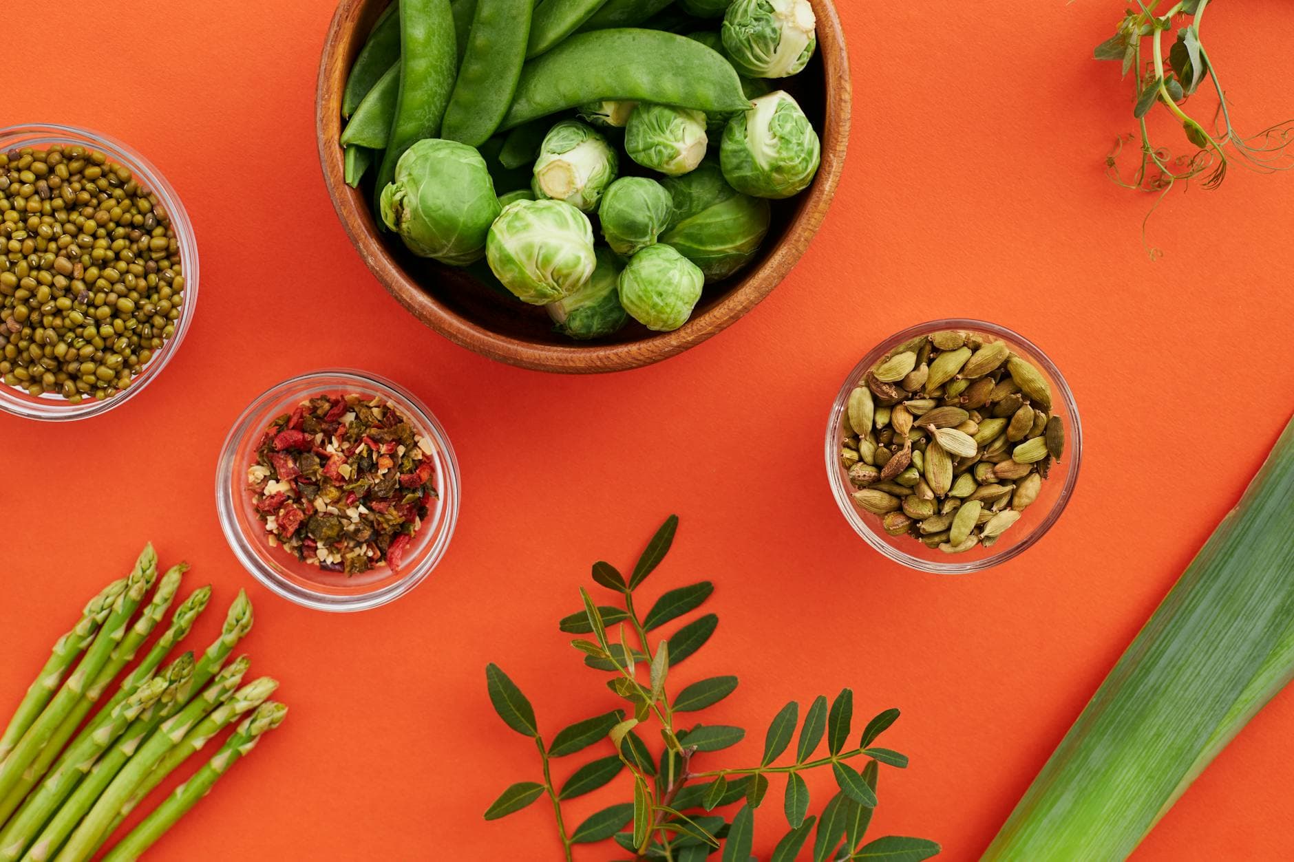 Vibrant display of nutritious vegetables and spices on a bold red background. - organic plant protein