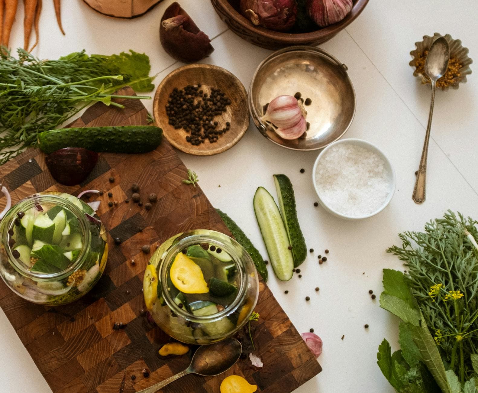 Aerial view of kitchen table with fresh vegetables and pickles preparation. - benefits of fermented foods