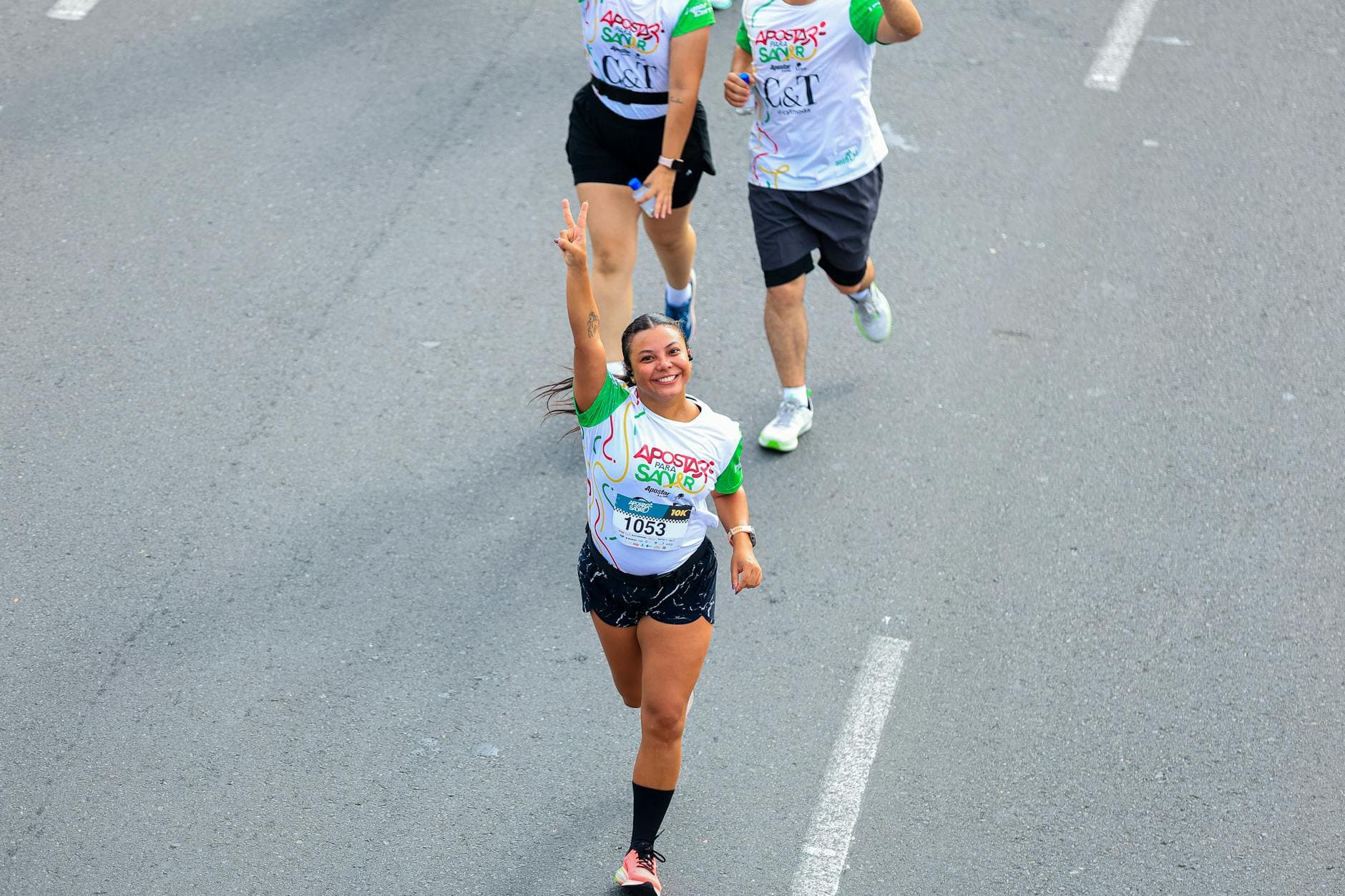 Smiling runners during a vibrant outdoor marathon, capturing a moment of celebration. - marathon recovery nutrition