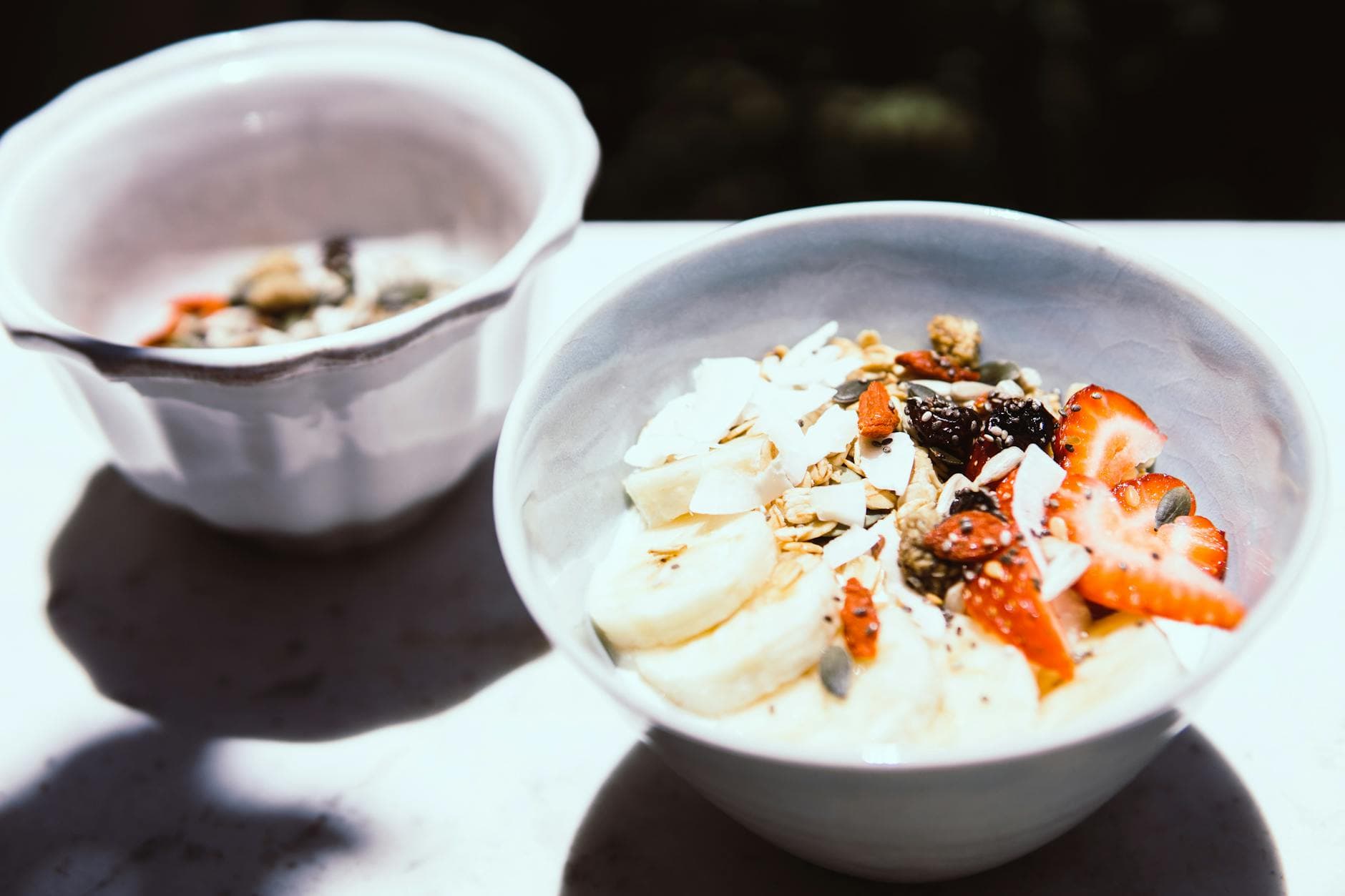 Discover a nutritious breakfast bowl featuring sliced bananas, strawberries, and granola, perfect for a healthy start. - probiotic recipes gut health