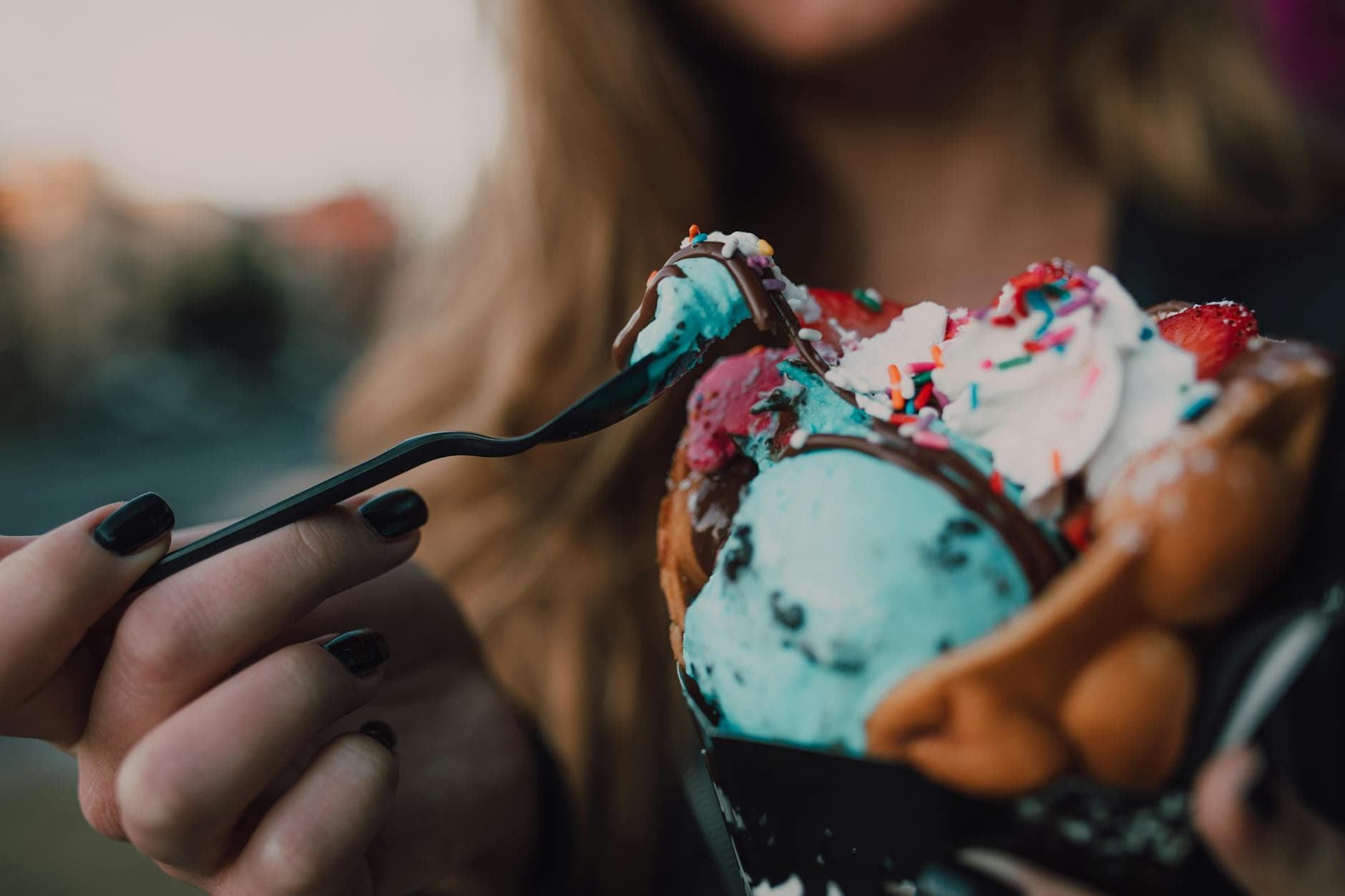 Close-up of colorful ice cream in a bubble waffle cone, perfect for dessert lovers. - spring sweet cravings