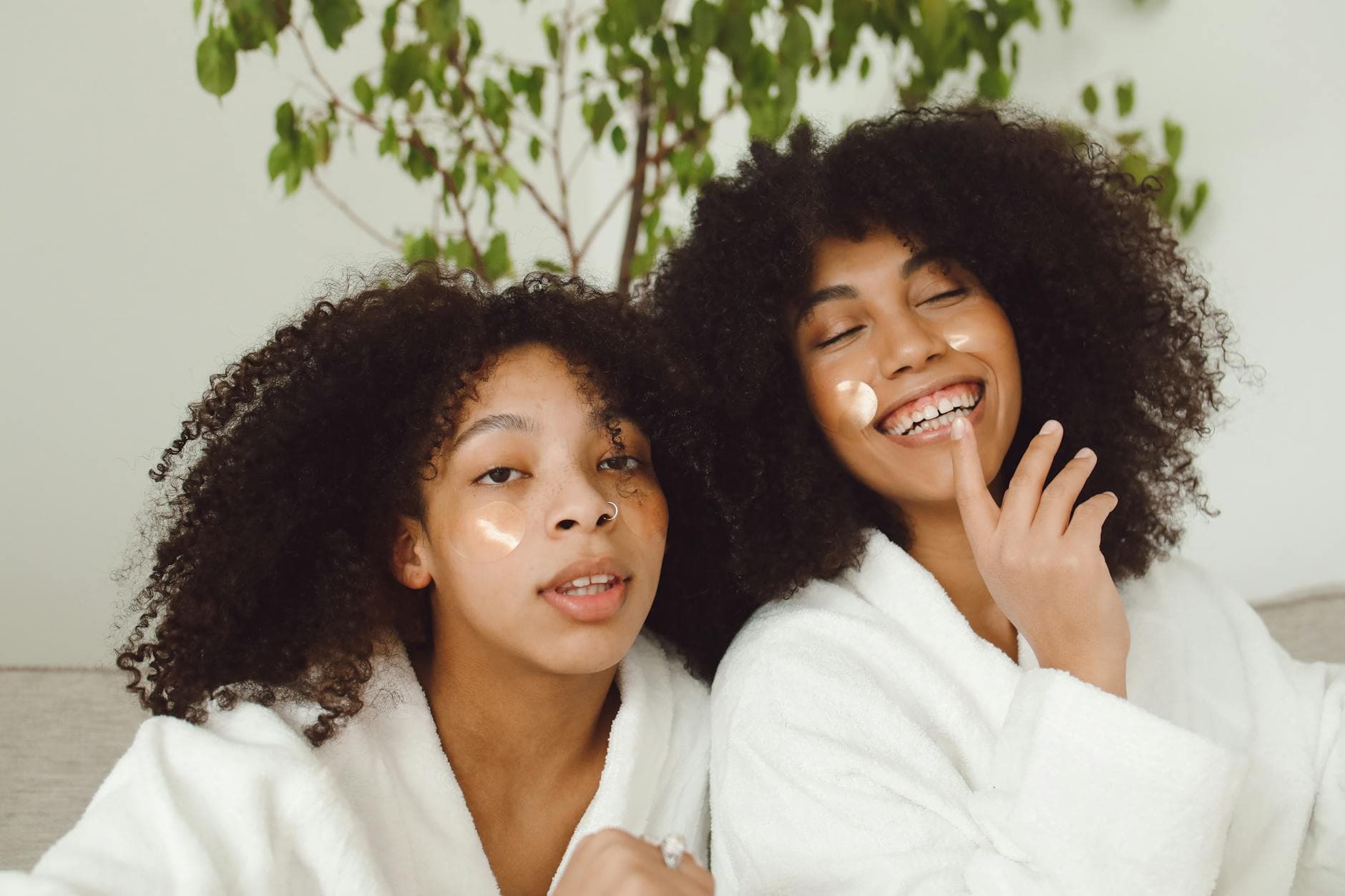 Two women enjoying a skincare routine, showcasing happiness and natural beauty. - best natural skincare products