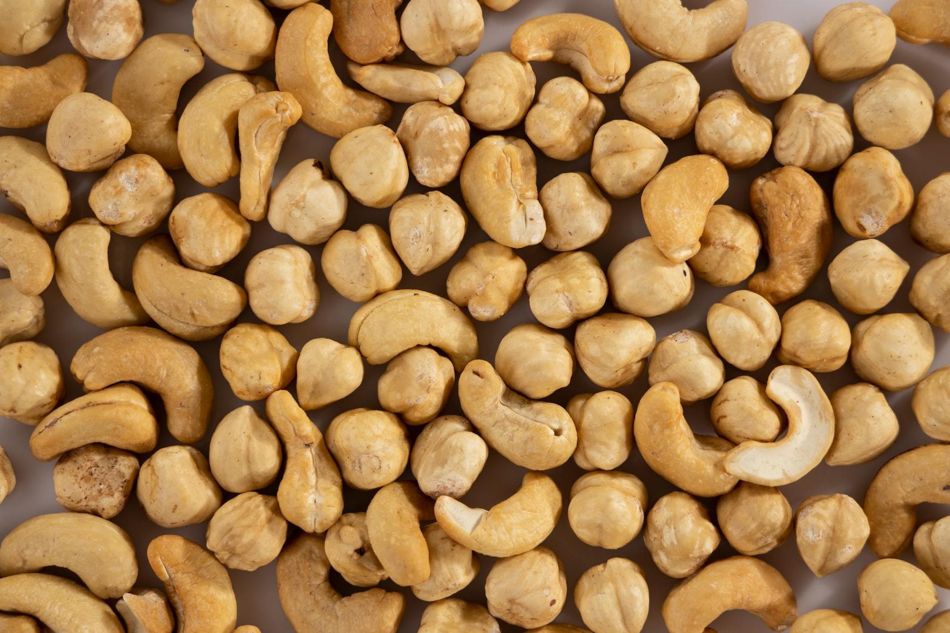Close-up of assorted cashew and macadamia nuts, showcasing texture and variety. - free keto recipes