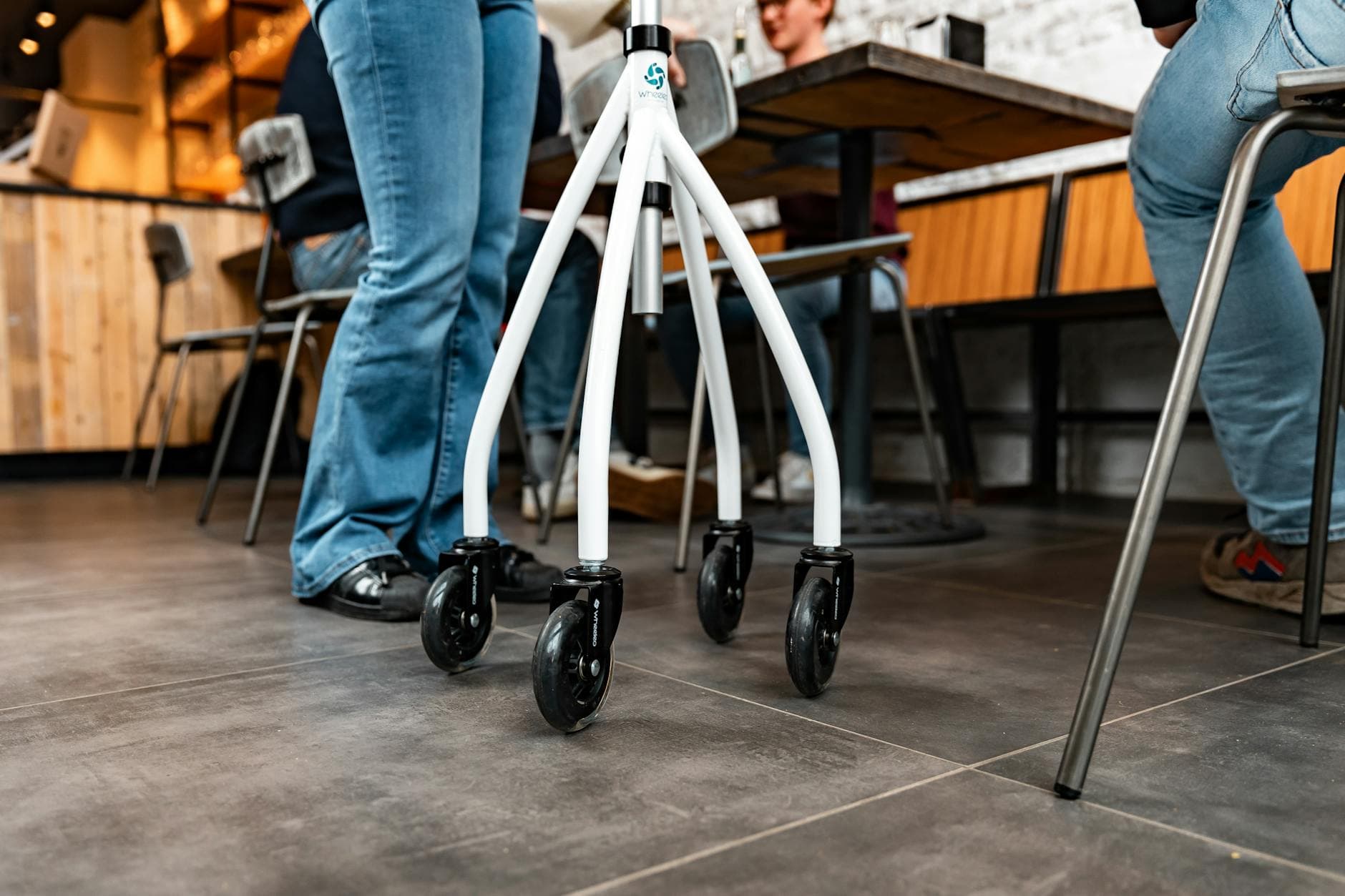 Rollator walker in a bustling café setting, surrounded by people socializing. - hip mobility exercises