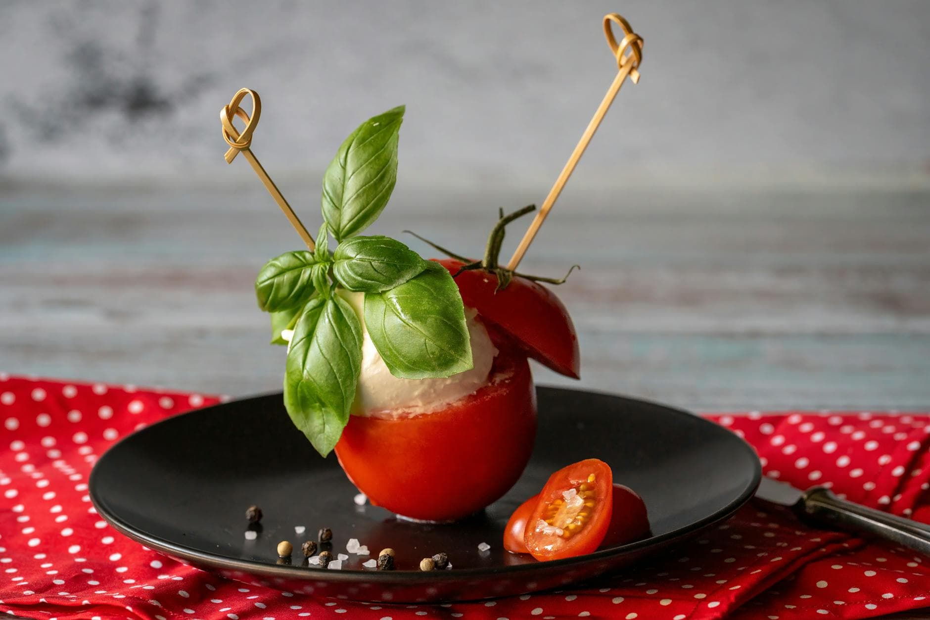 Delicious Caprese salad featuring fresh mozzarella, ripe tomatoes, and basil leaves on a stylish plate. - healthy snack recipes