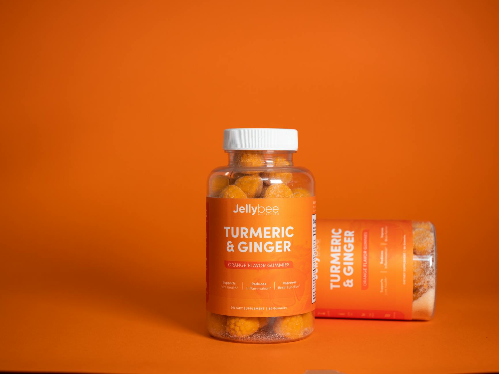 Vibrant product shot of Jellybee turmeric and ginger gummies in an orange setting. - anti inflammatory recipes