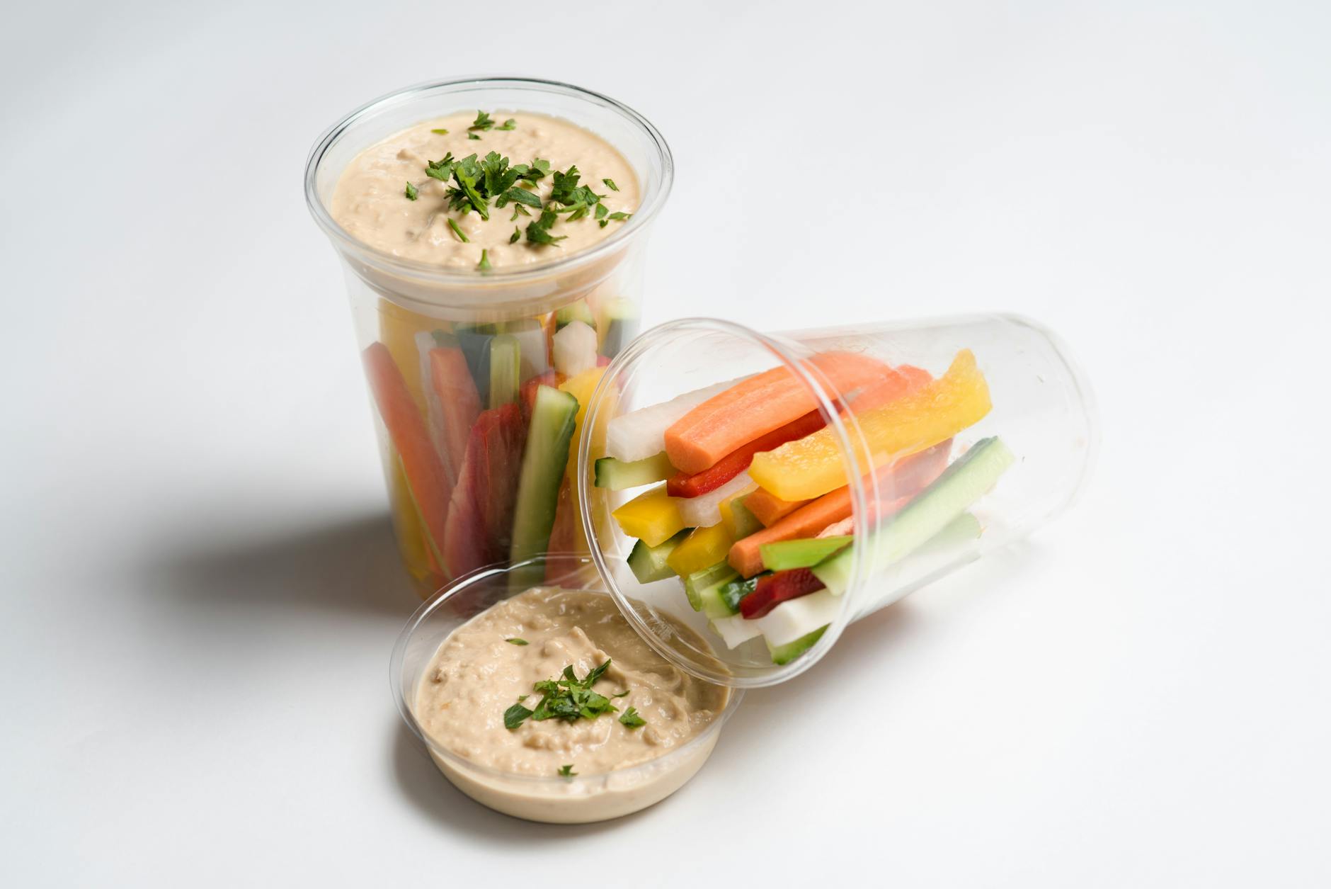 Fresh vegetable sticks with a creamy dip in clear cups, perfect for snacks. - best costco healthy snacks
