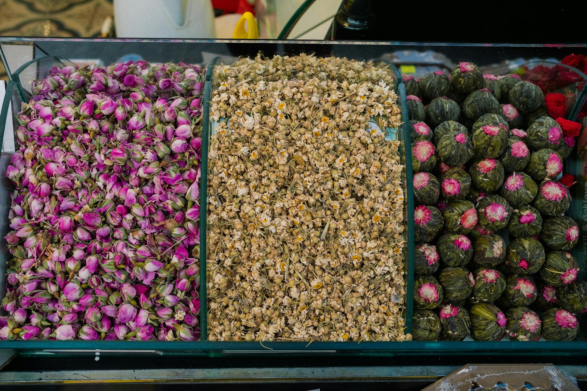 Top view of assorted dried flowers including rosebuds, chamomile, and blooming teas for herbal blends. - bloom greens benefits