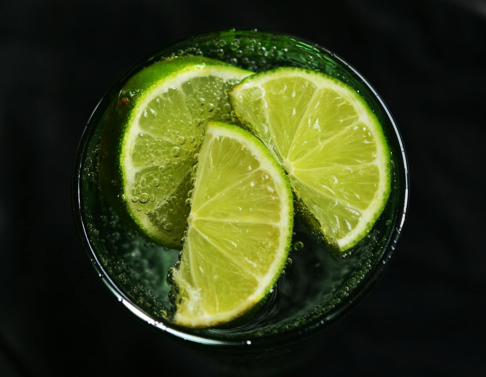 Close-up of fresh lime slices in a glass of sparkling water, refreshing concept. - detox water recipes