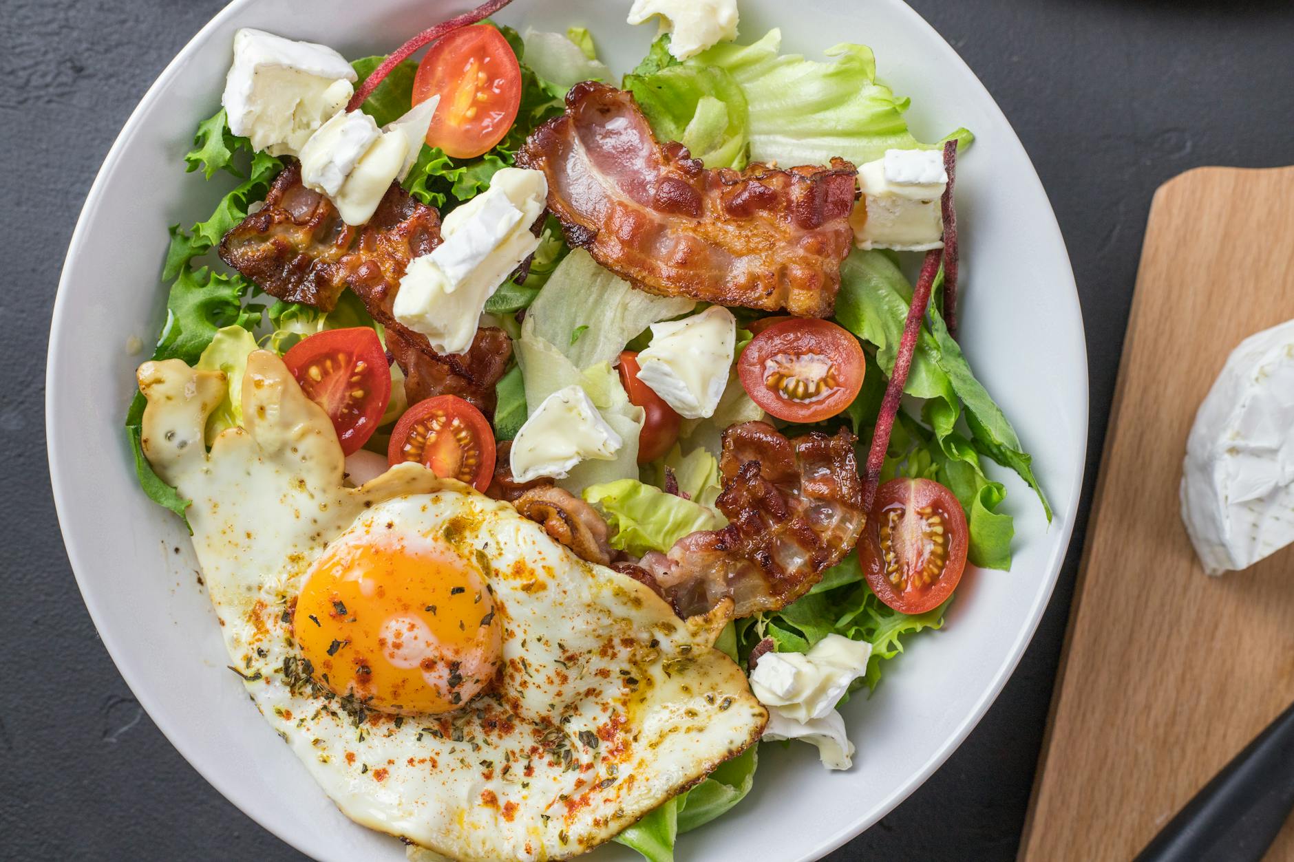 Fresh ketogenic salad with bacon, egg, feta, and tomatoes, perfect for healthy eating. - easy keto recipes
