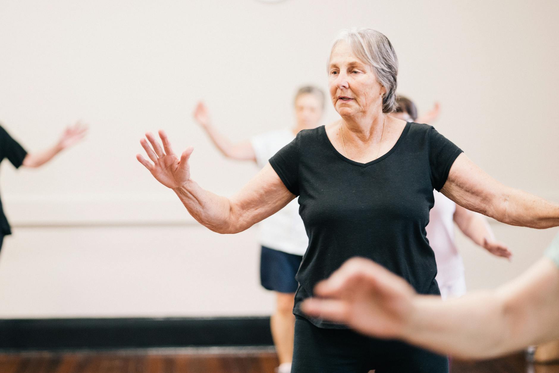 Elderly women enjoying a fitness group exercise session indoors. - healthy aging tips seniors