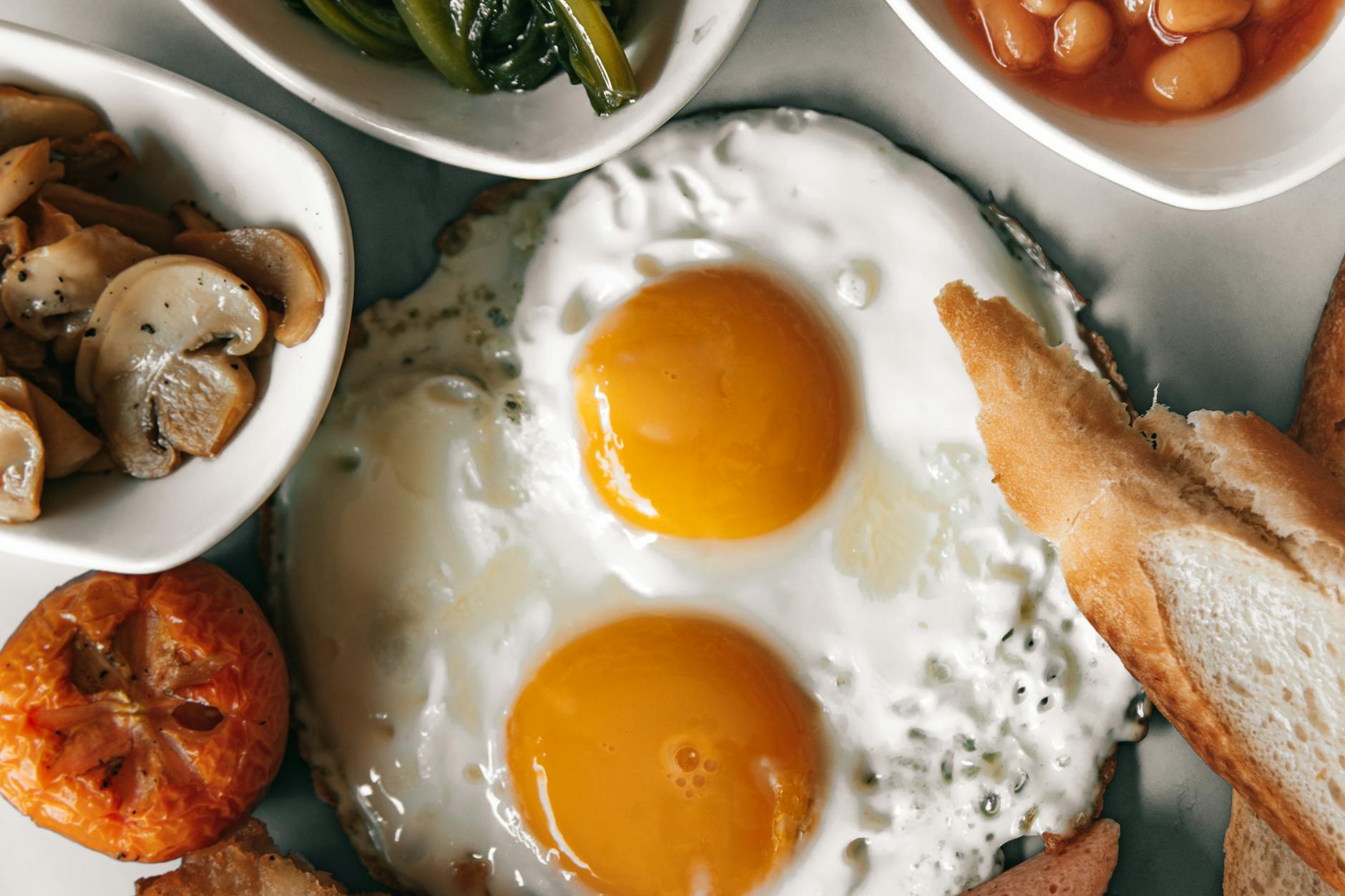 A delectable breakfast spread featuring eggs, bread, and fresh vegetables. - healthy breakfast eggs