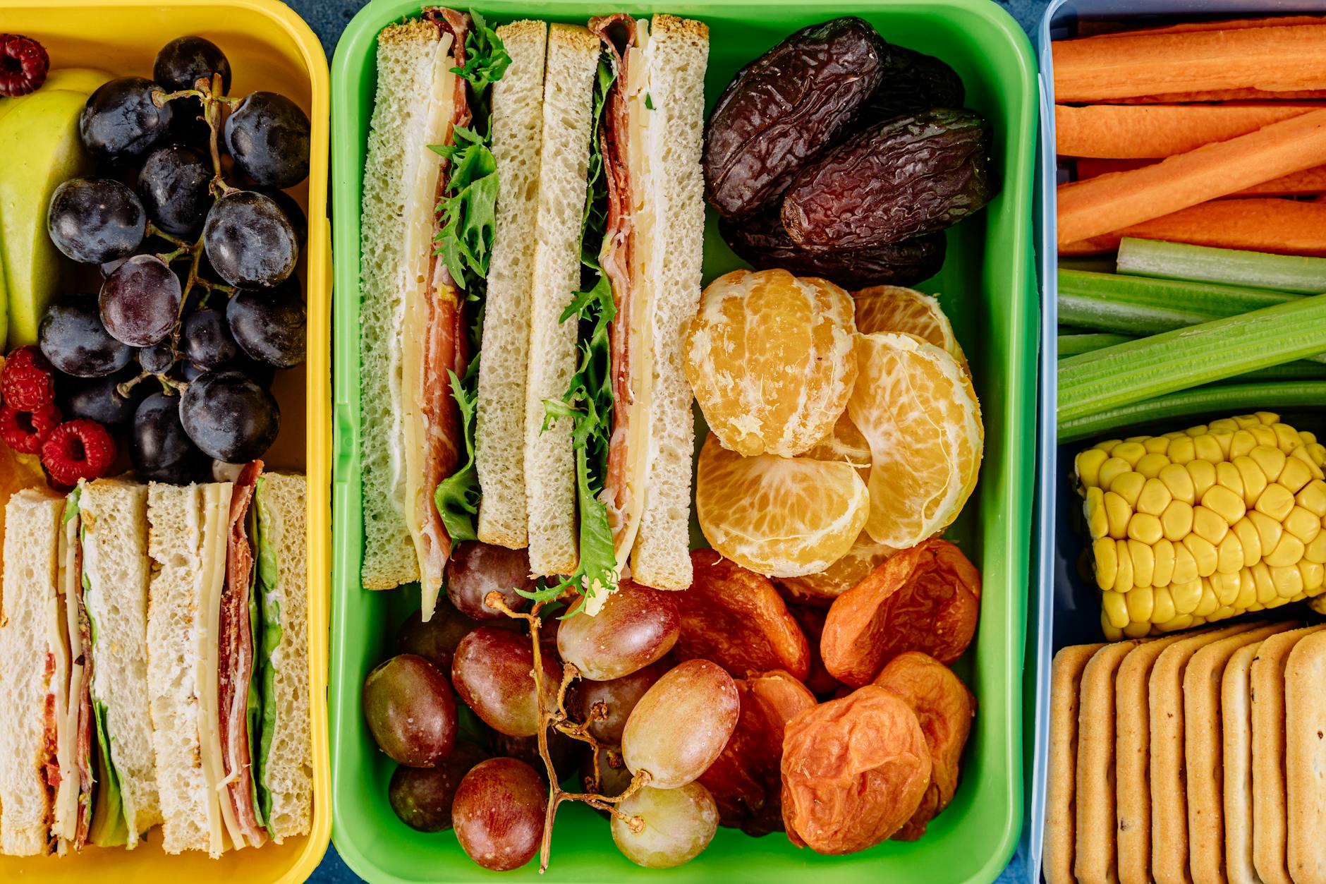 Colorful lunchbox filled with sandwiches, fresh fruits, and vegetables, perfect for a healthy meal. - healthy work lunch ideas