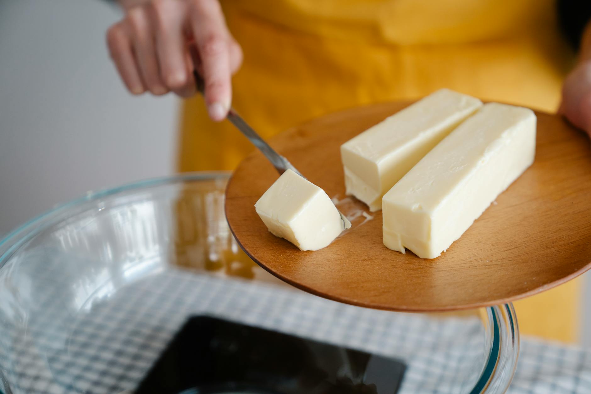 Focused shot of cutting butter for meal preparation, essential cooking ingredient. - keto instant pot recipes