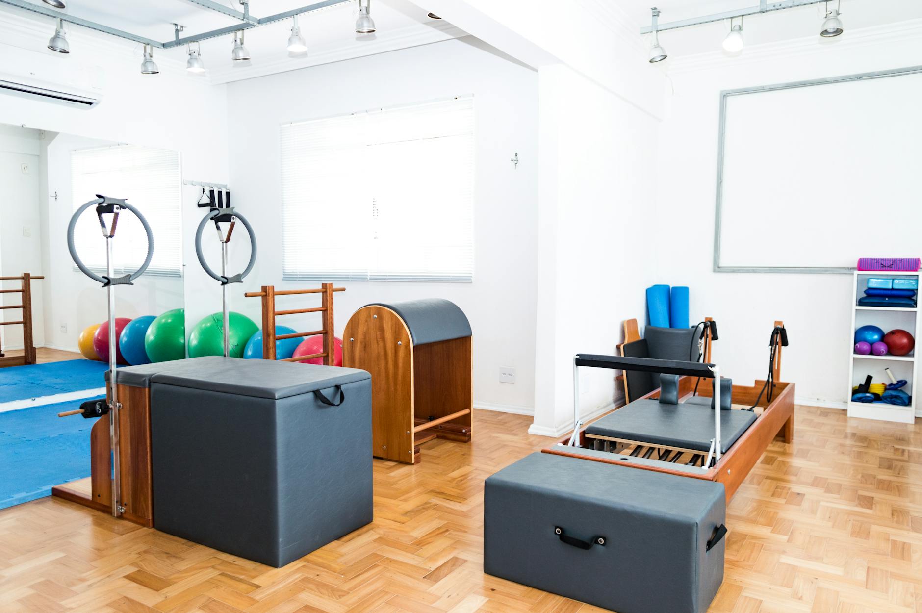 Spacious Pilates studio with modern equipment and vibrant exercise balls. - pilates for pelvic floor