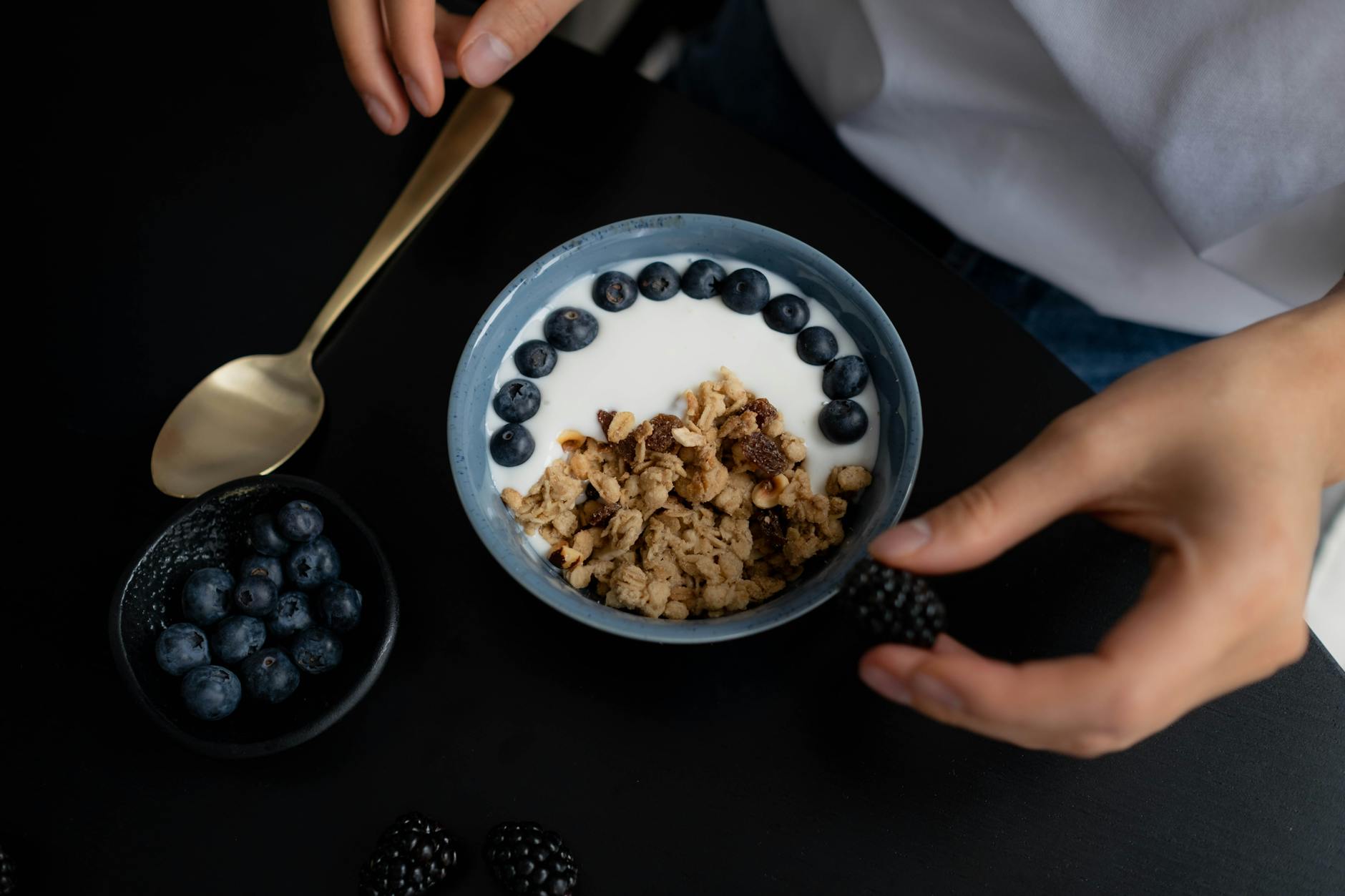 A delicious breakfast bowl featuring granola, yogurt, blueberries, and blackberries, perfect for a healthy start. - protein foods for weight loss