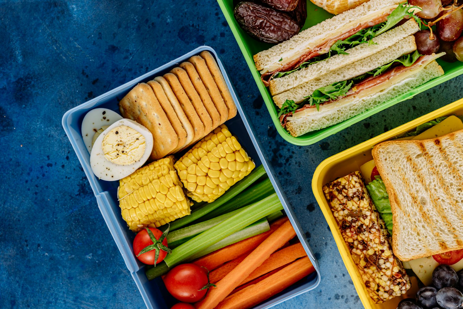 Colorful lunchboxes featuring sandwiches, vegetables, and snacks for healthy eating. - quick healthy lunches