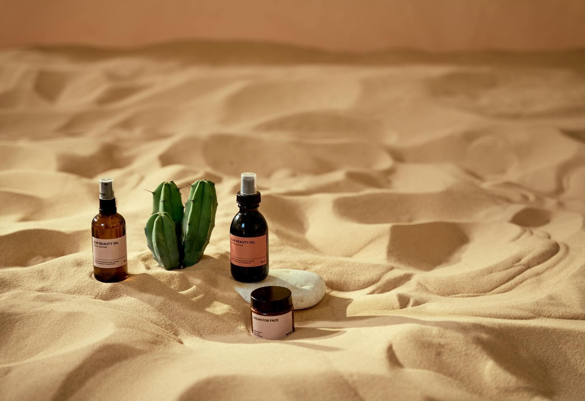 Elegant skincare bottles on sand with aloe, highlighting natural beauty and serenity. - best organic skincare
