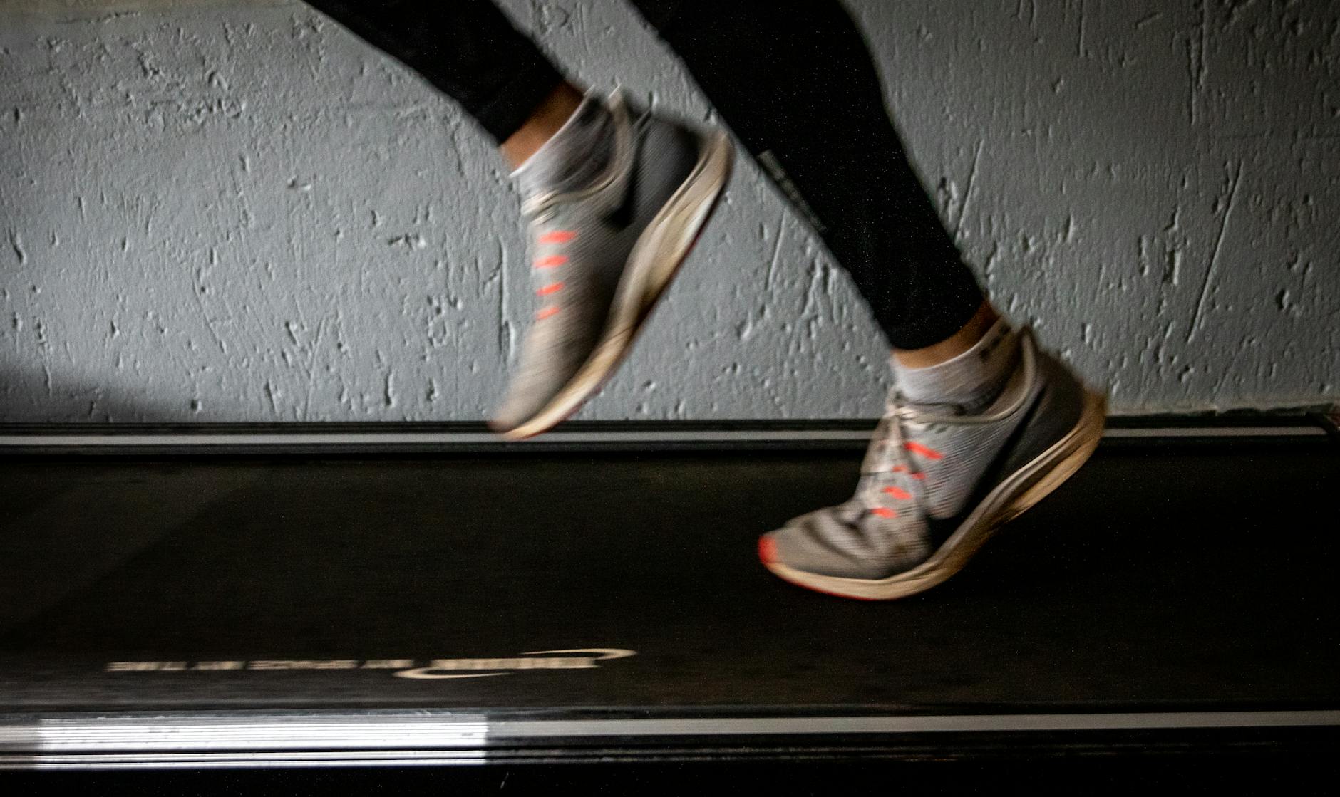Blurred image of a person running on a treadmill, emphasizing movement and speed. - cardio fat burning