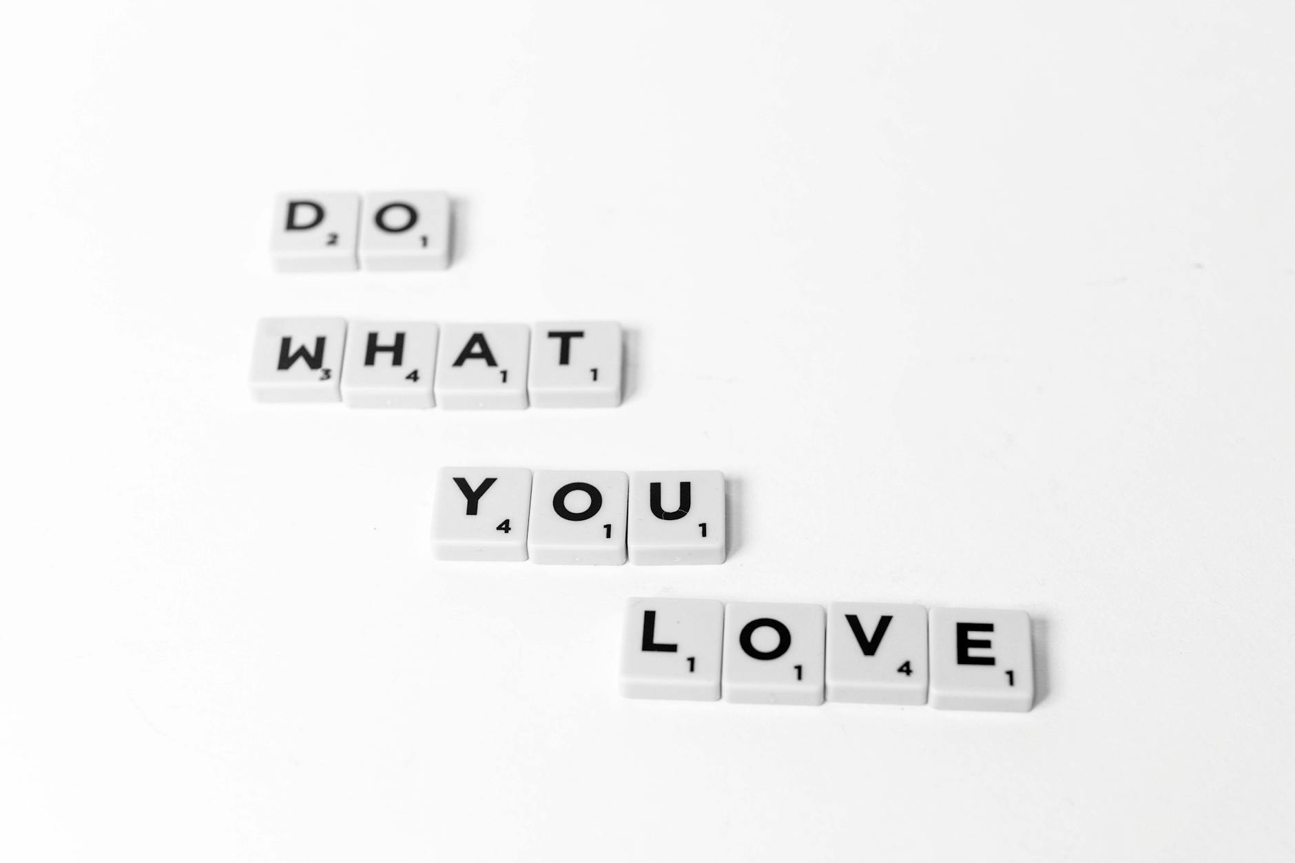 Scrabble tiles spelling 'Do What You Love' on a minimalist white background. - what is core