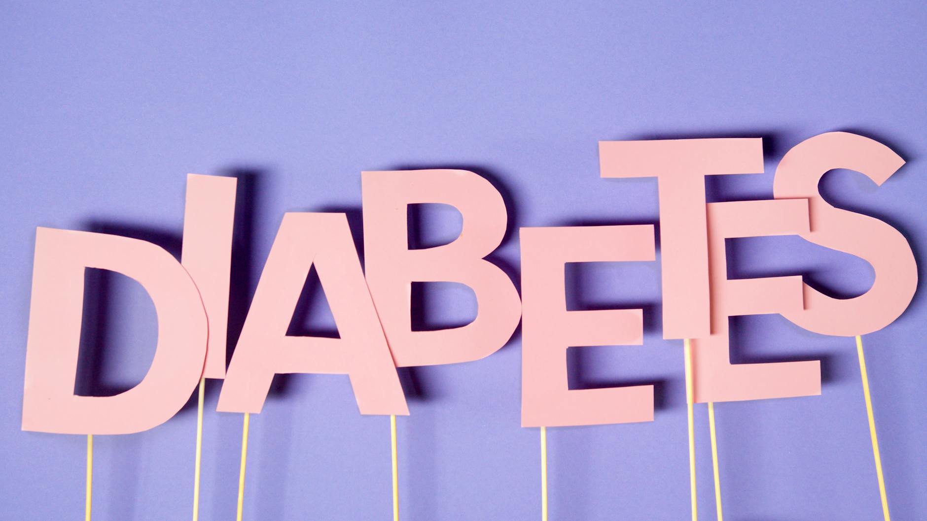 Creative conceptual image of diabetes awareness with pink letters on purple background. - diabetic snack ideas