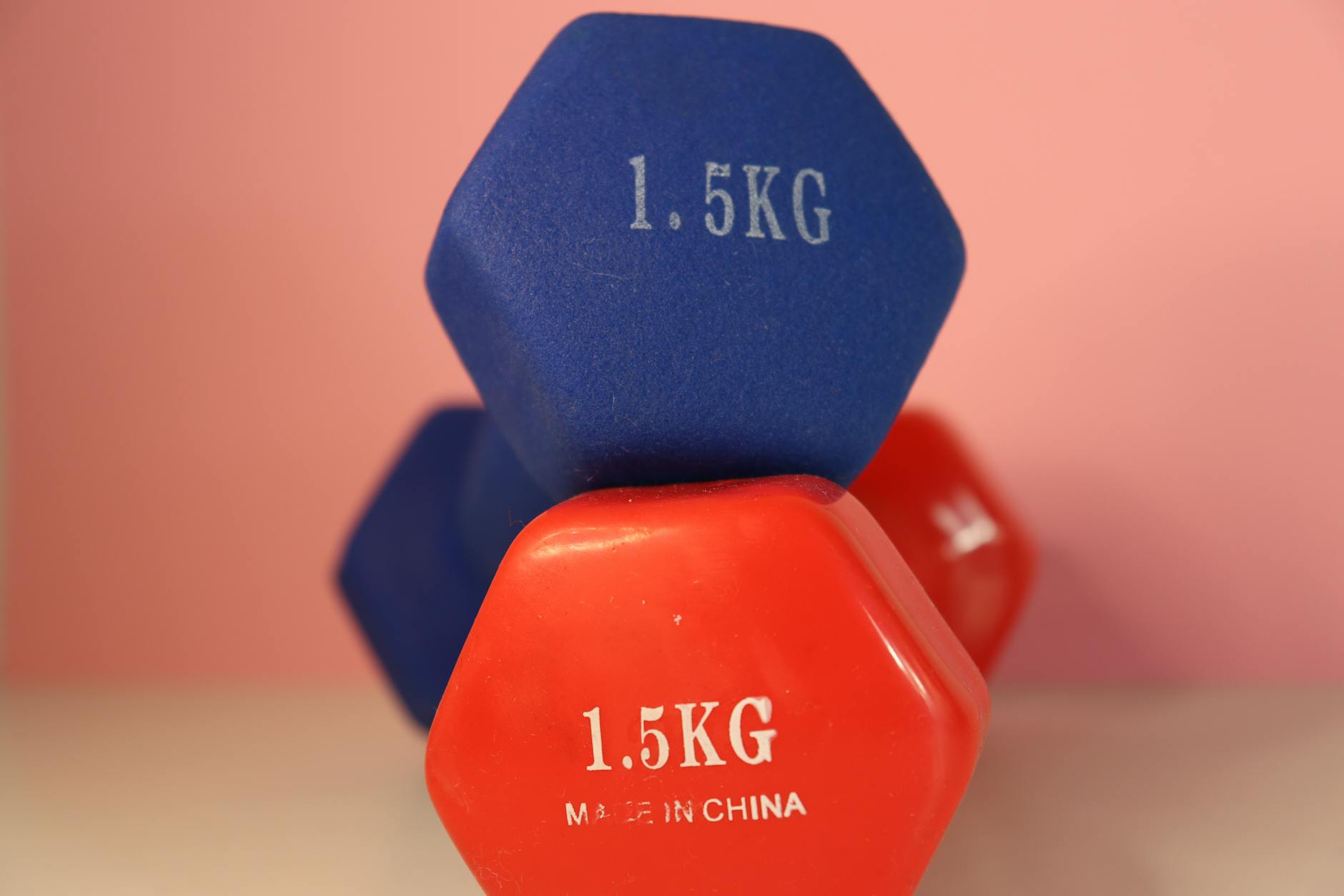 Close-up of blue and red 1.5 kg dumbbells for gym and weightlifting. - dumbbell workout