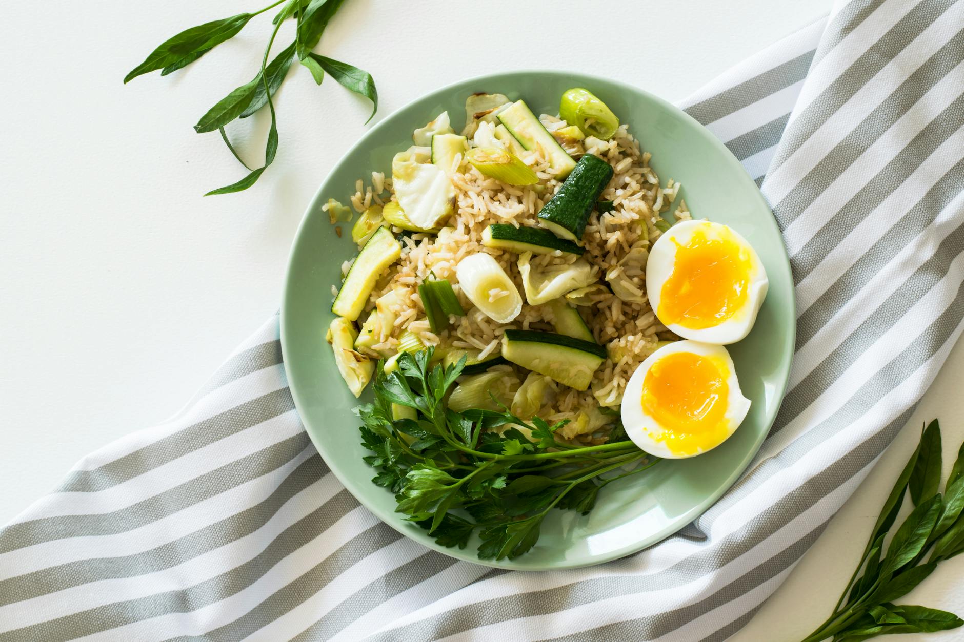 Delicious rice meal with zucchini, greens, and soft-boiled egg, perfect for a healthy diet. - easy healthy dinners