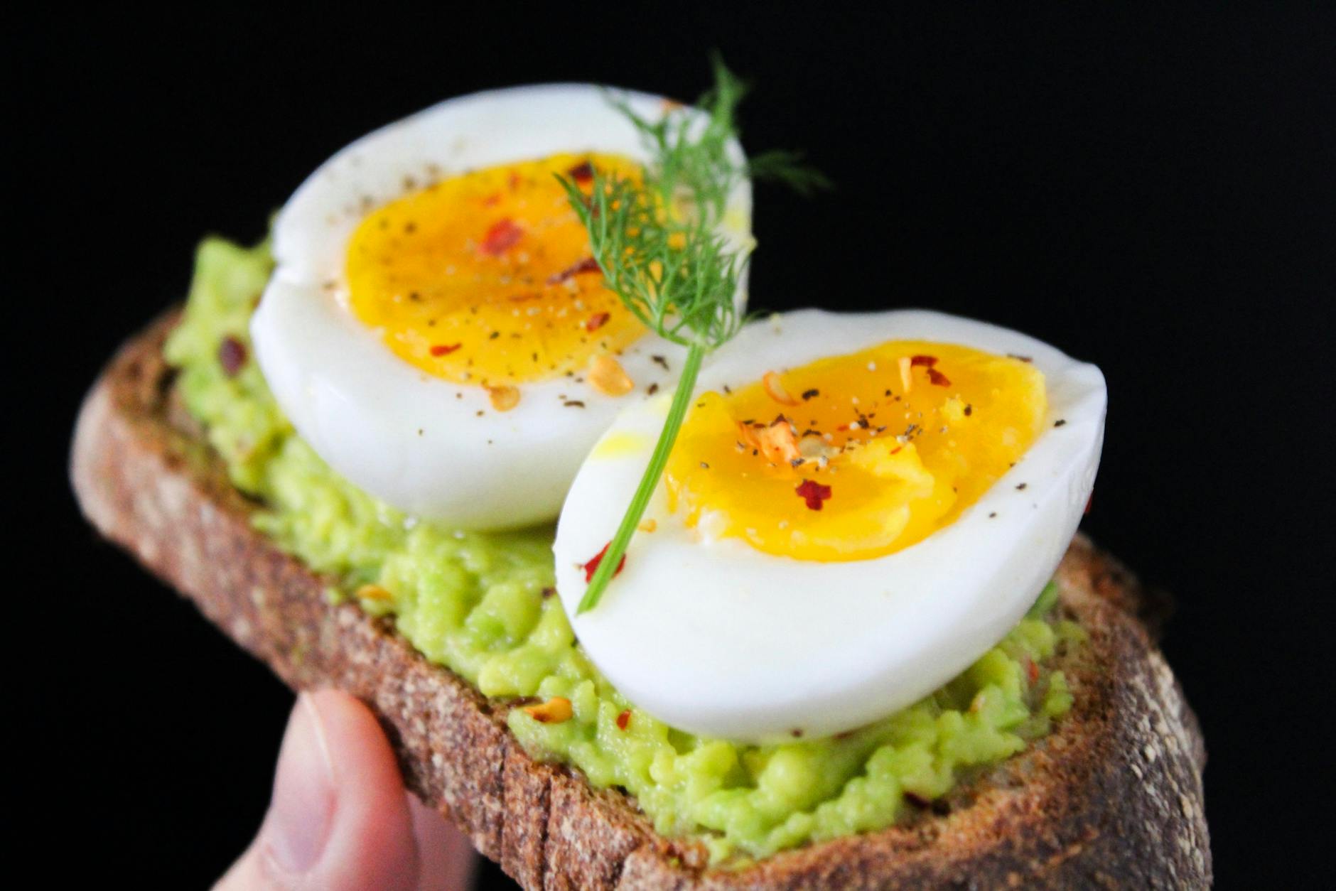 A delicious and healthy avocado toast topped with soft-boiled eggs, perfect for a nutritious breakfast. - healthy breakfast sandwich
