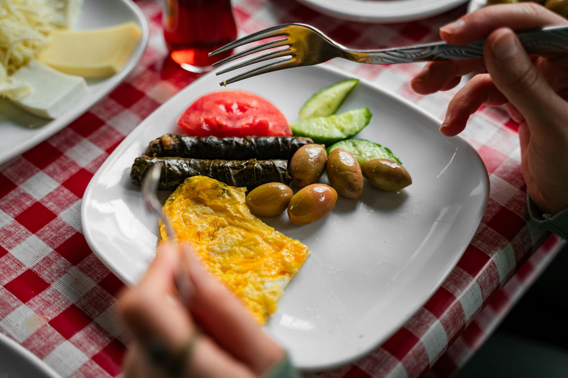 A vibrant plate of traditional Turkish breakfast with olives, omelette, and fresh vegetables in Bursa. - healthy fast food breakfast