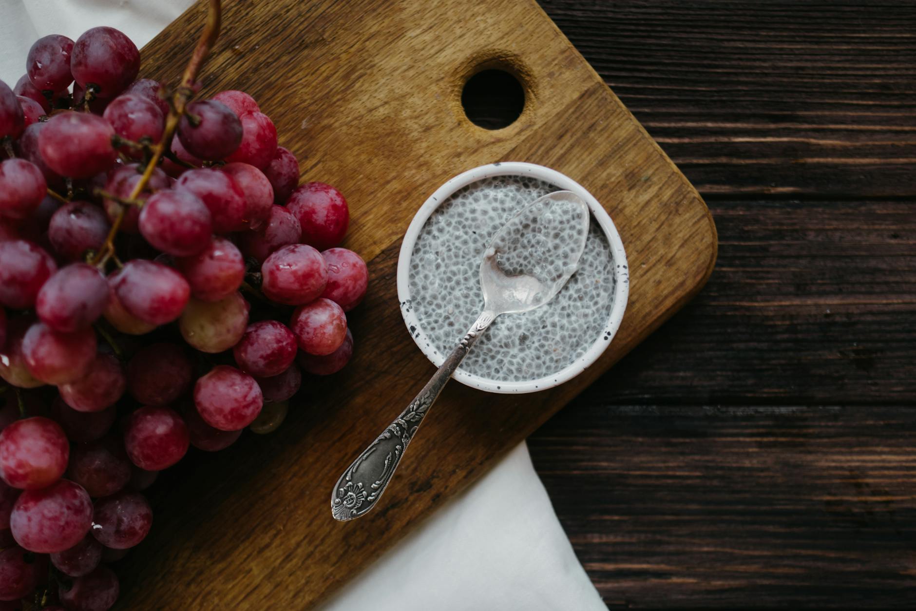 Healthy chia pudding with red grapes on rustic wooden background. - healthy lunch recipes