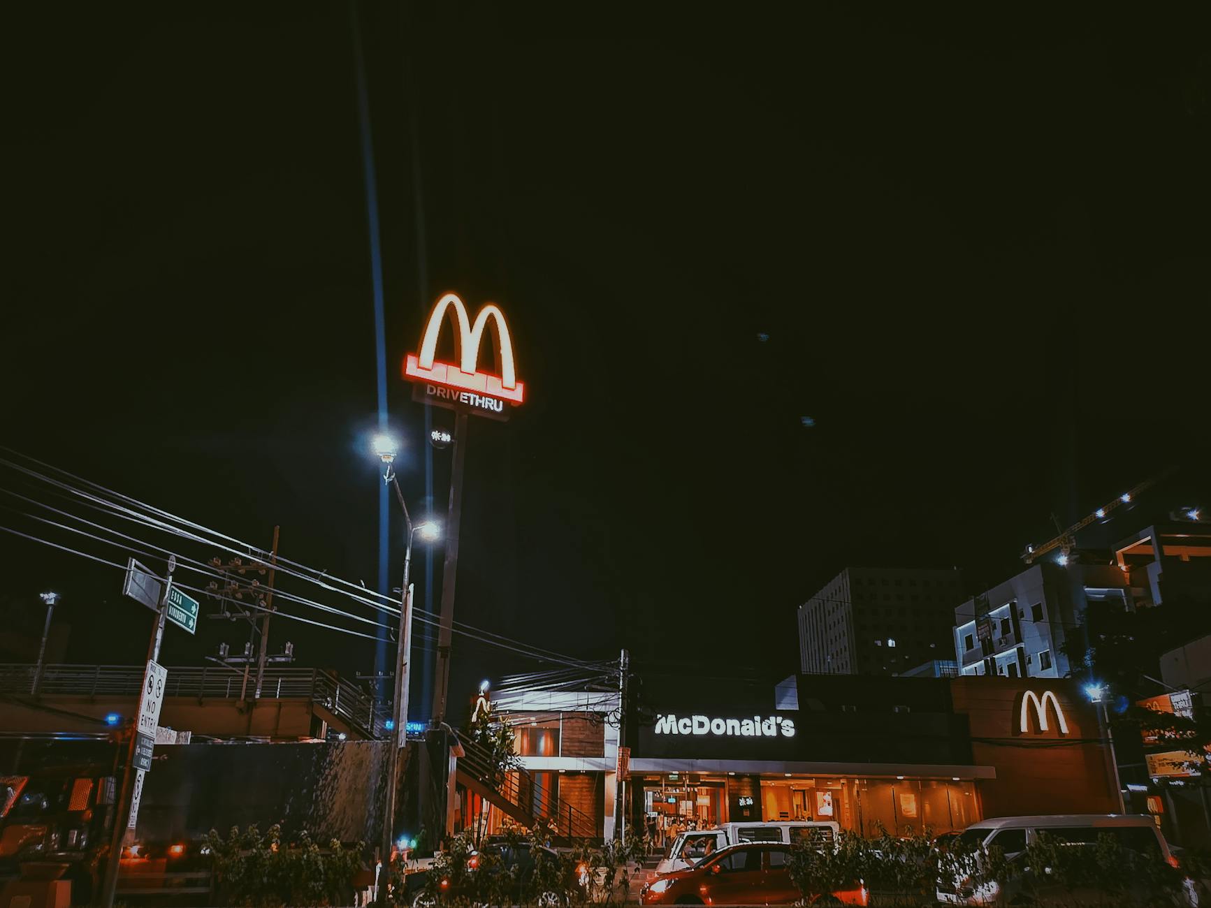 A brightly lit McDonald's restaurant in a city setting during nighttime, showcasing neon signage. - healthy mcdonalds breakfast