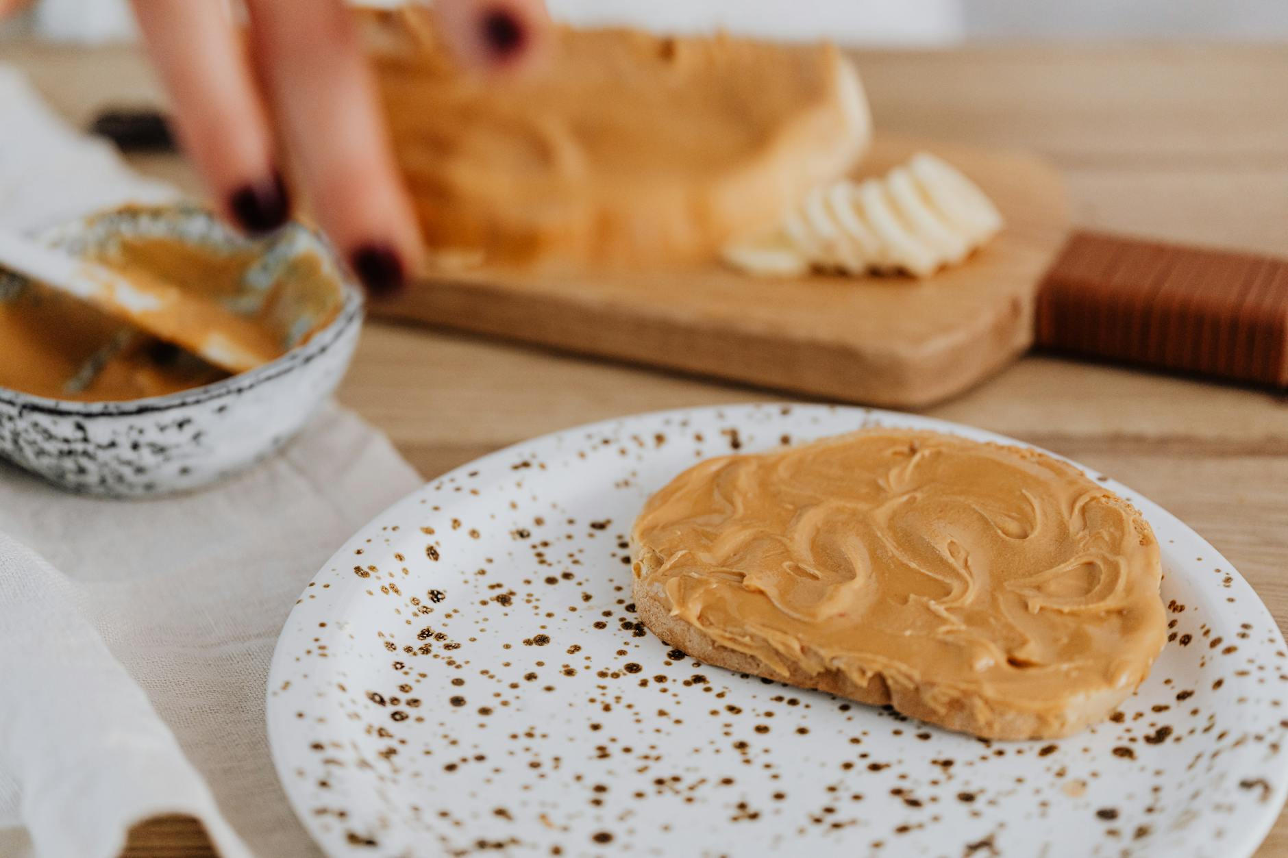 Artistic close-up of creamy peanut butter spread on toast. - healthy peanut butter snacks