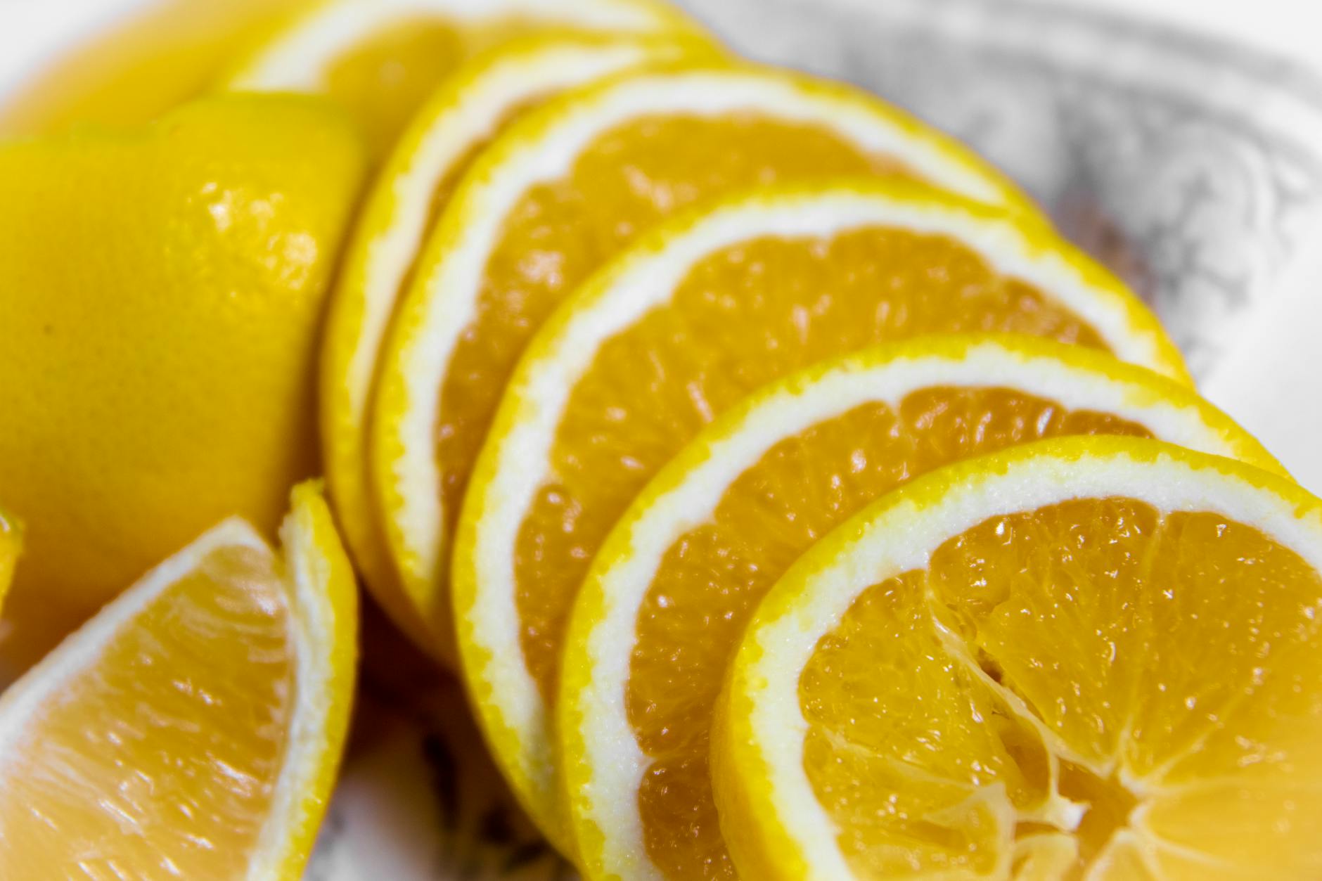 Close-up of vibrant orange slices on a decorative plate, ideal for food photography. - healthy snacks near me