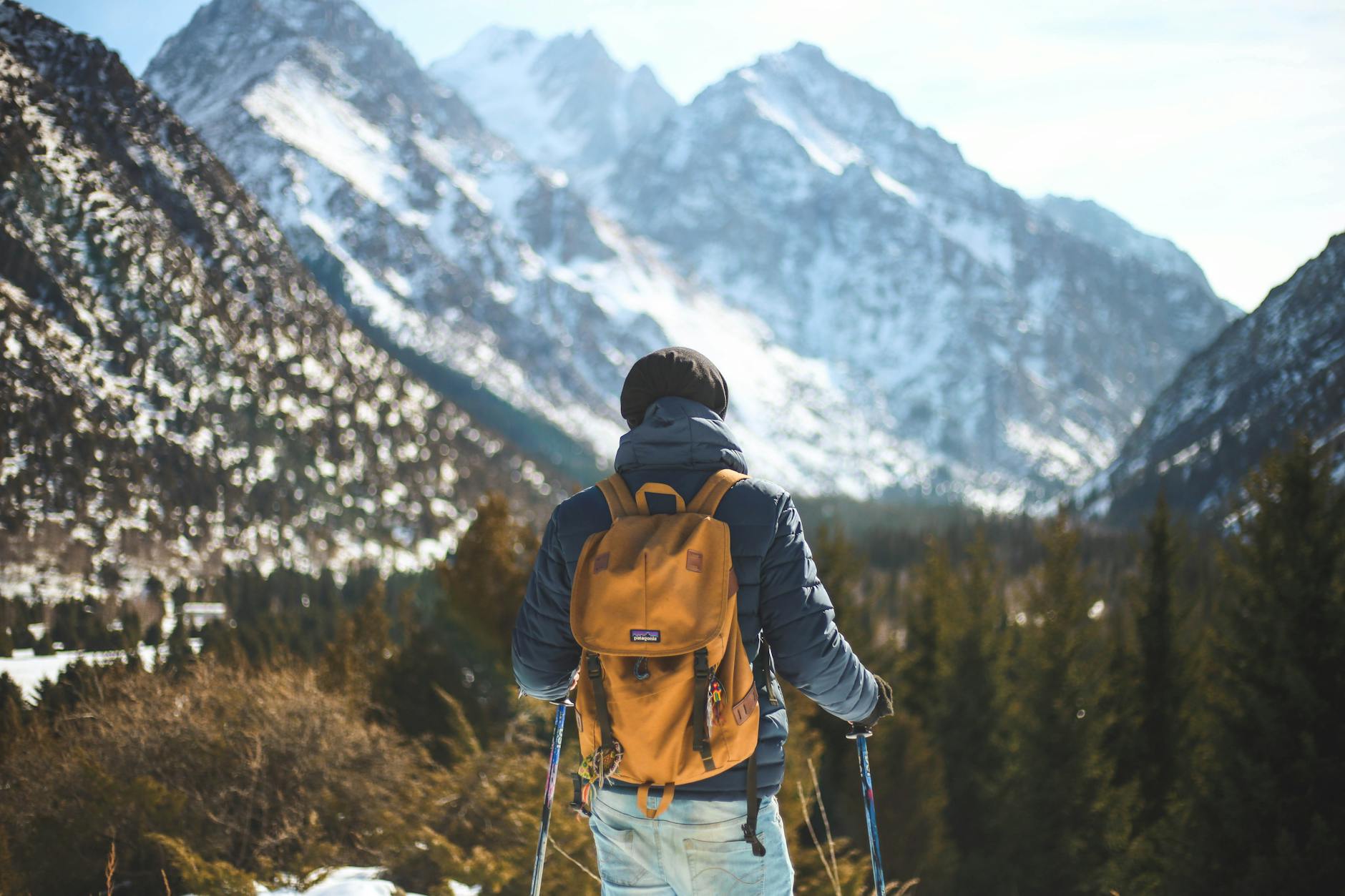 A lone hiker with a backpack explores a scenic winter mountain landscape. - hiking for weight loss