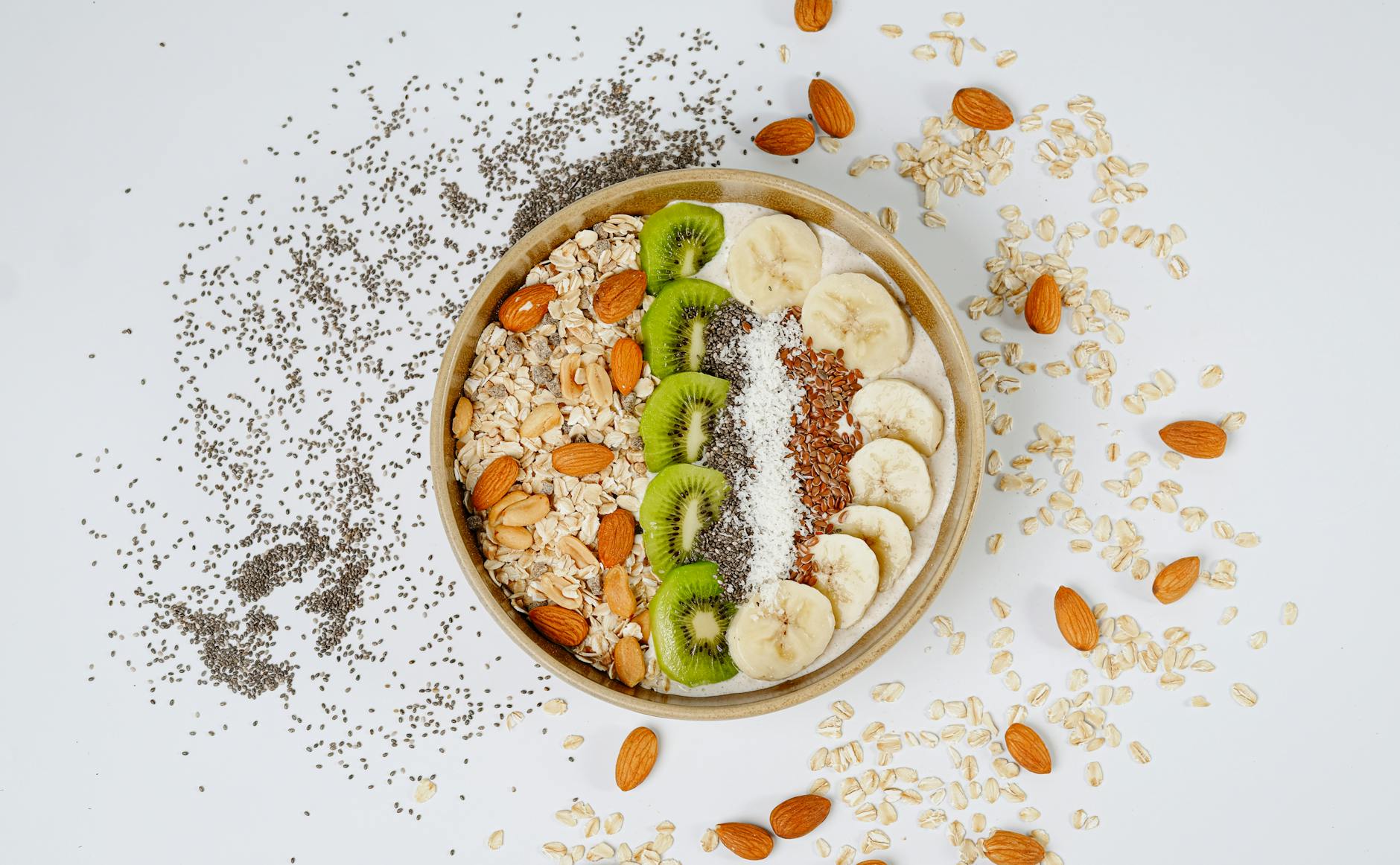A delicious and nutritious breakfast bowl with kiwi, banana, almonds, and chia seeds. - probiotic foods boost