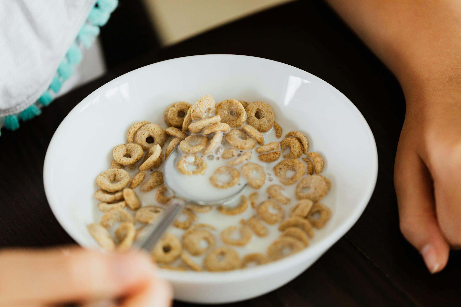 A close-up view of a bowl of cereal with milk, captured from above. - quick healthy breakfast