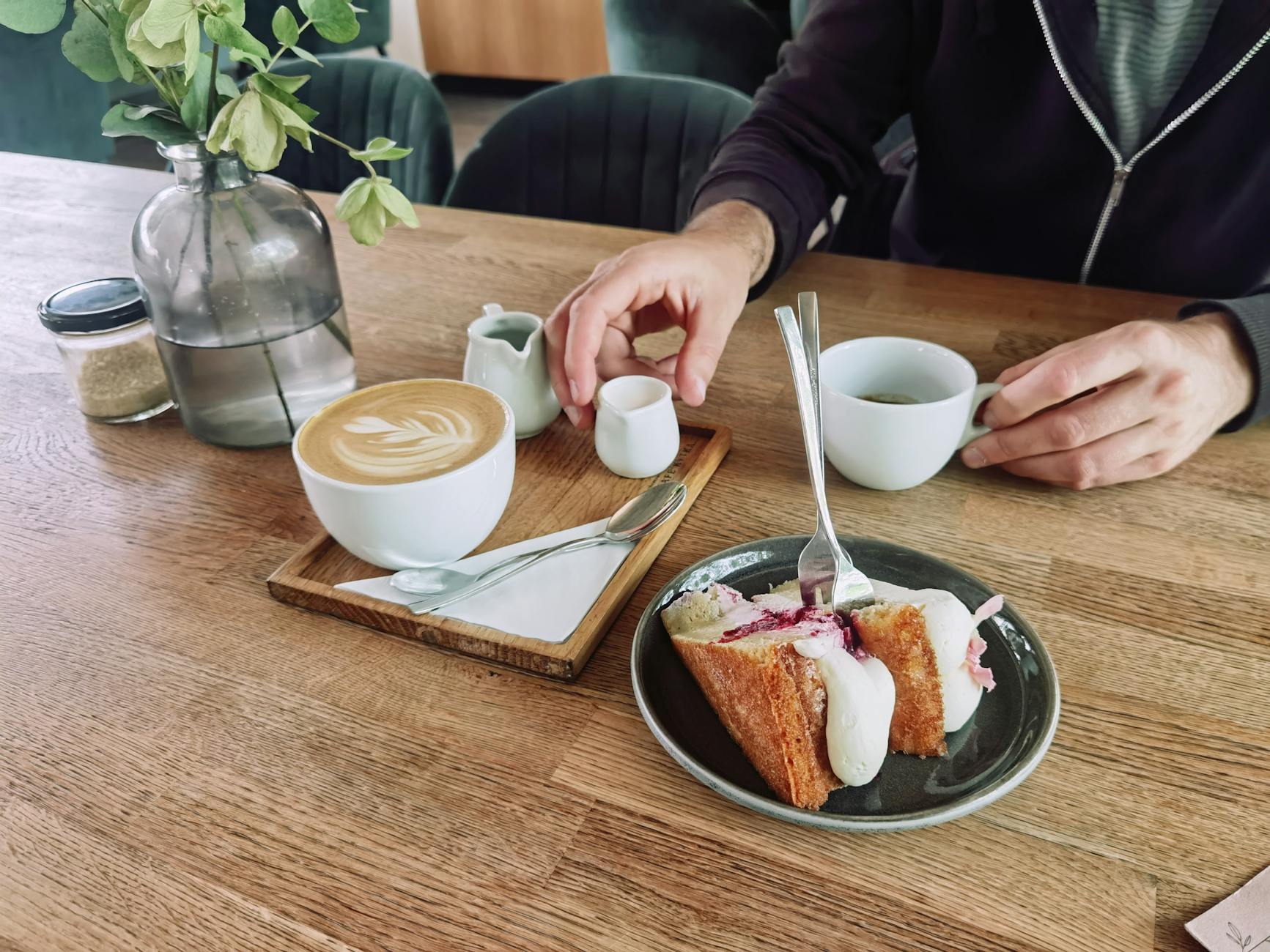 A relaxing café scene with a cup of coffee and a slice of cake, perfect for lifestyle themes. - seated good morning