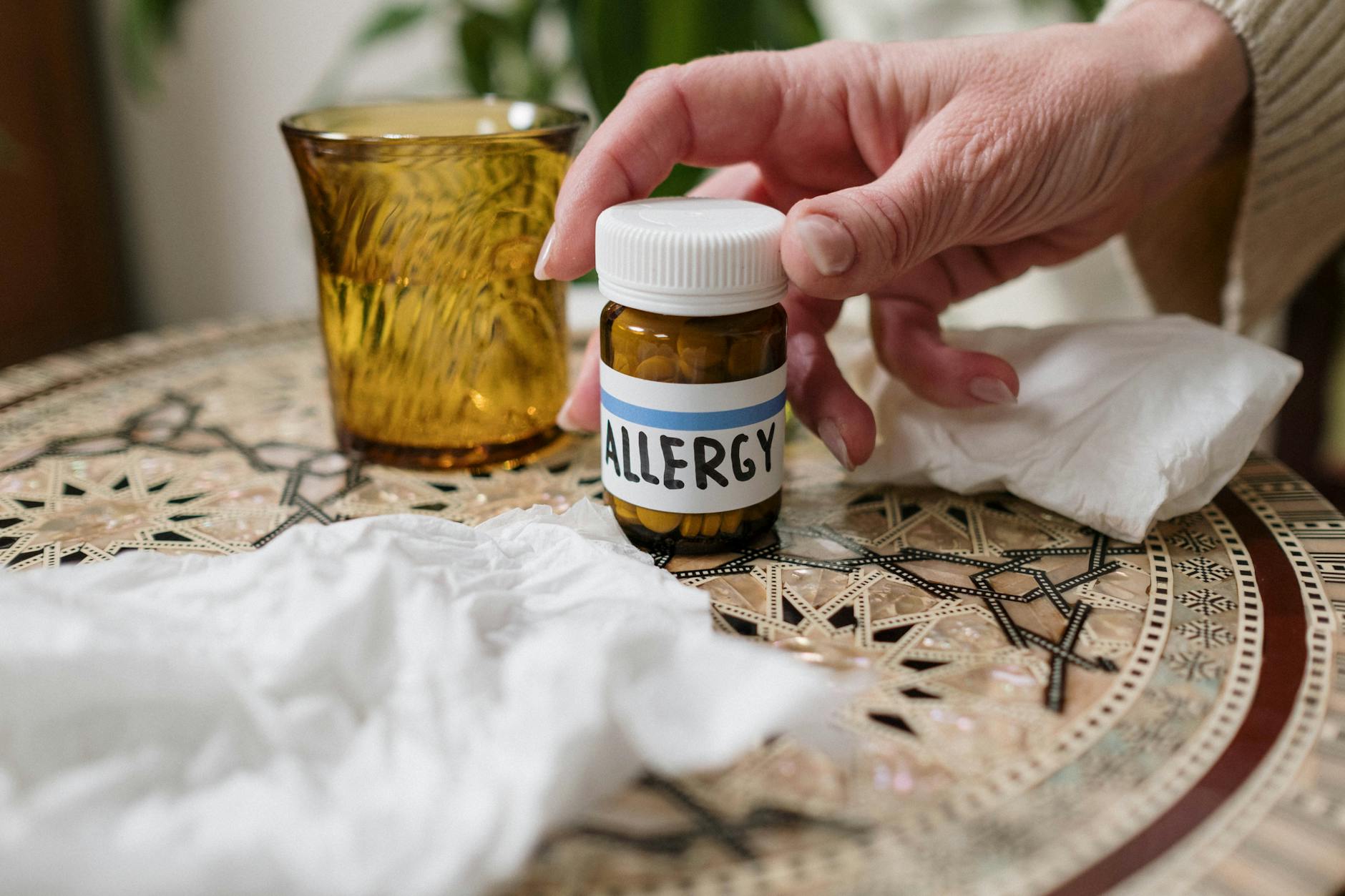 A close-up of allergy medication bottle on table with tissues, ideal for health themes. - spring allergy relief