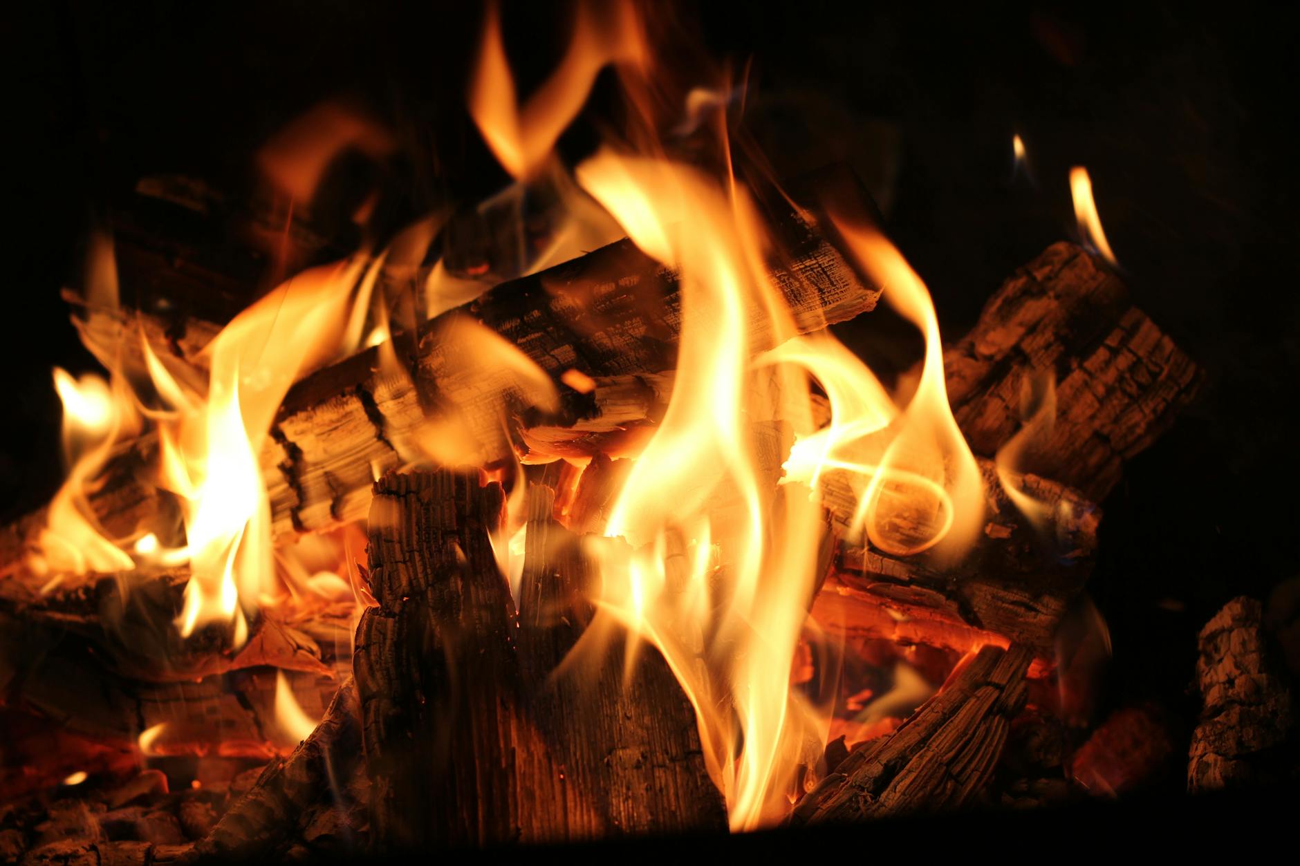 Warm and inviting close-up view of a burning fireplace with glowing wood logs and flames. - spring fat burning