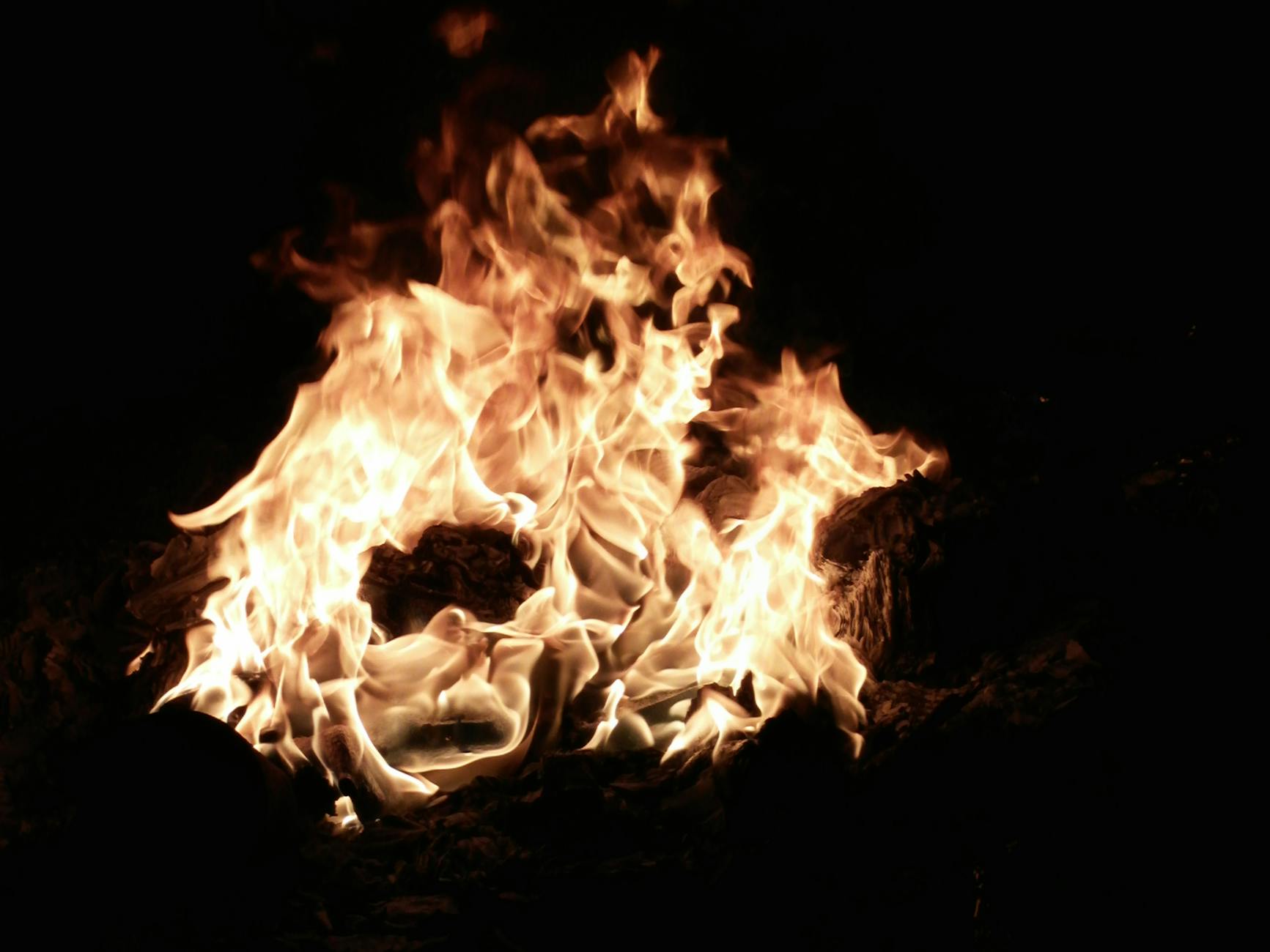 Close-up capture of blazing flames and glowing embers in a dark setting, evoking warmth and intensity. - spring fat burning