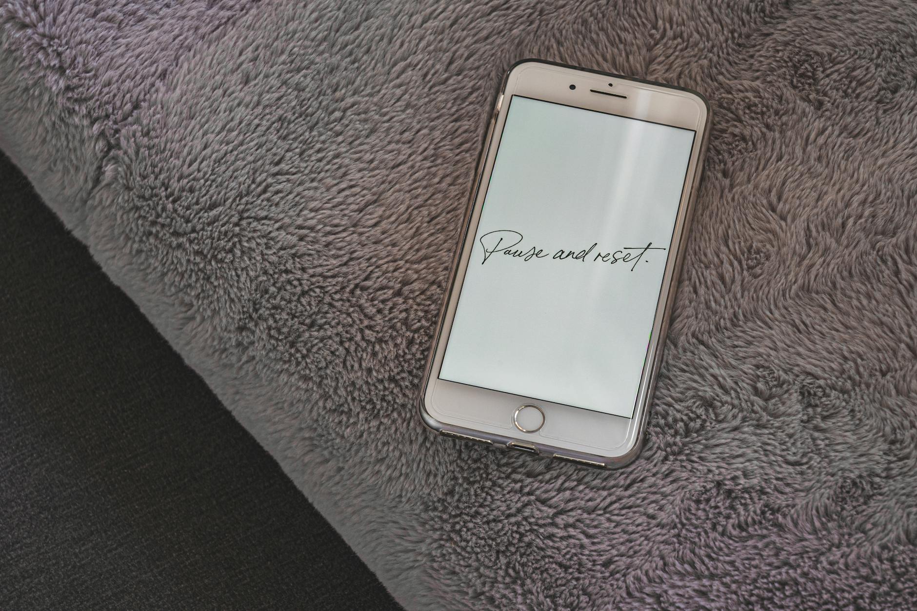 A smartphone on a plush surface with an inspirational message, ideal for motivational themes. - spring reset challenge